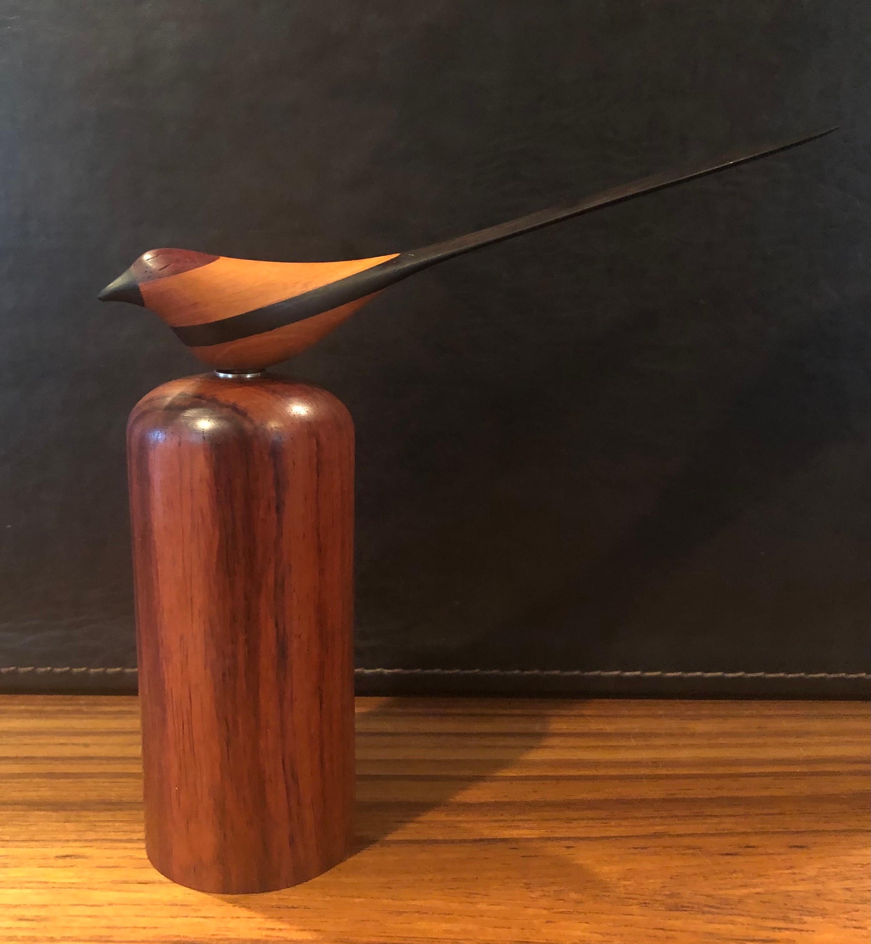 Fabulous MCM hand carved bird sculpture in mixed woods on a rosewood pedestal signed RYO?, circa 1970s. The piece is of exceptionally high quality and attaches to the solid rosewood pedestal via a strong magnet. It is signed on the bottom and is in