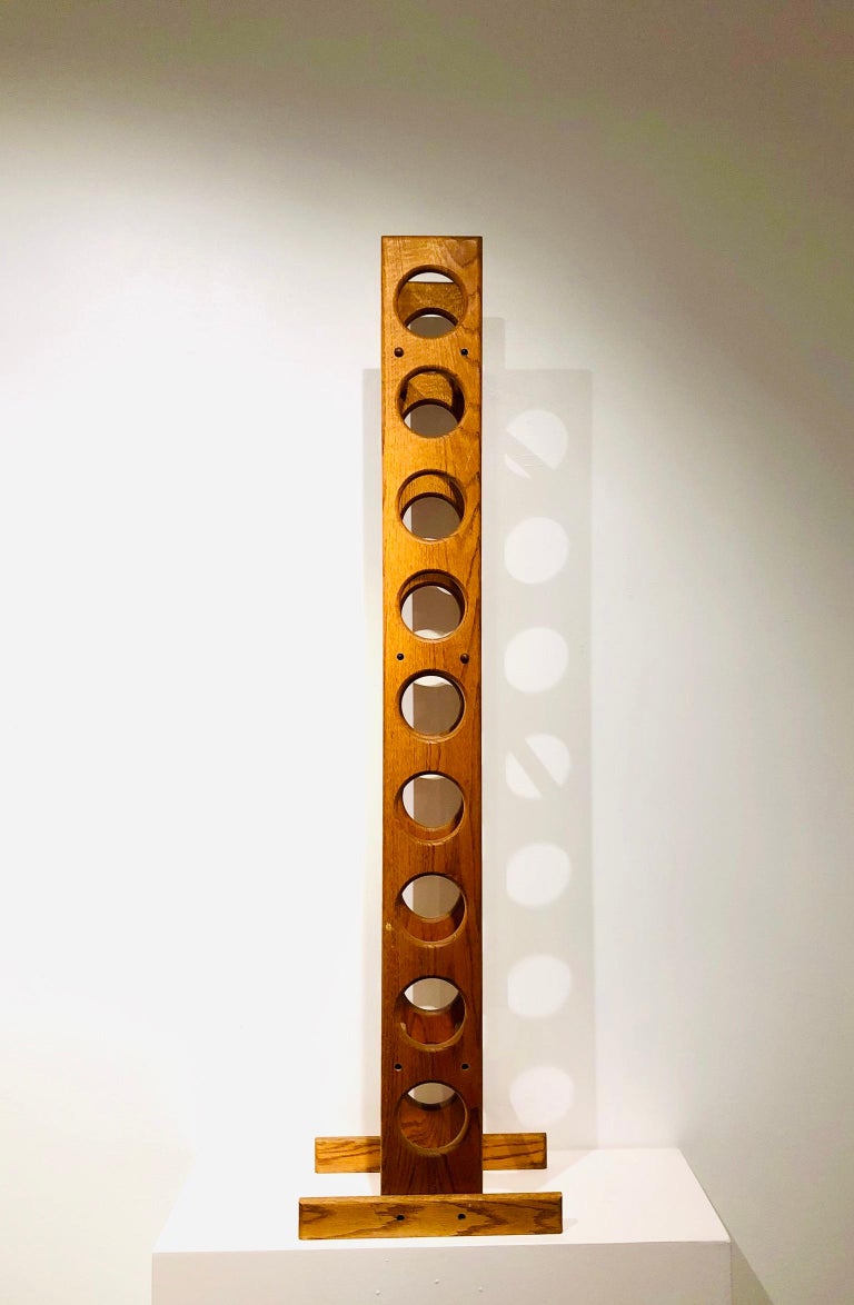 Beautiful and unique free standing solid oak handcrafted wine rack circa 1970s, we belive it was designed by Lou Hodges California design.
