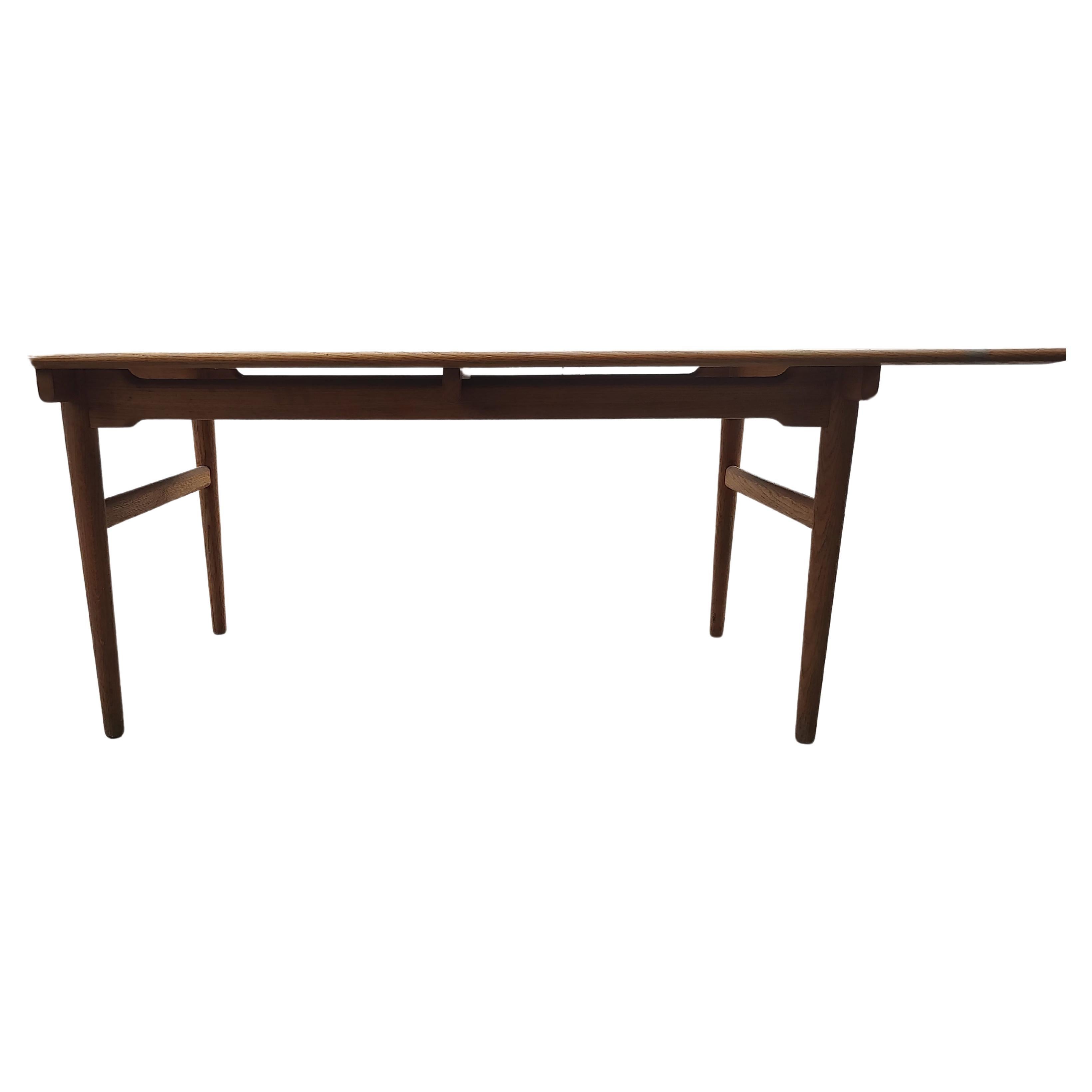 Fantastic simple yet very elegant dining table CH327 by Hans J Wegner  for Carl Hansen & Son. Oak top with a teak frame and legs. Solid wood top appears to be floating above the frame. Signed, tagged in center of tables underside. Beautiful sculpted