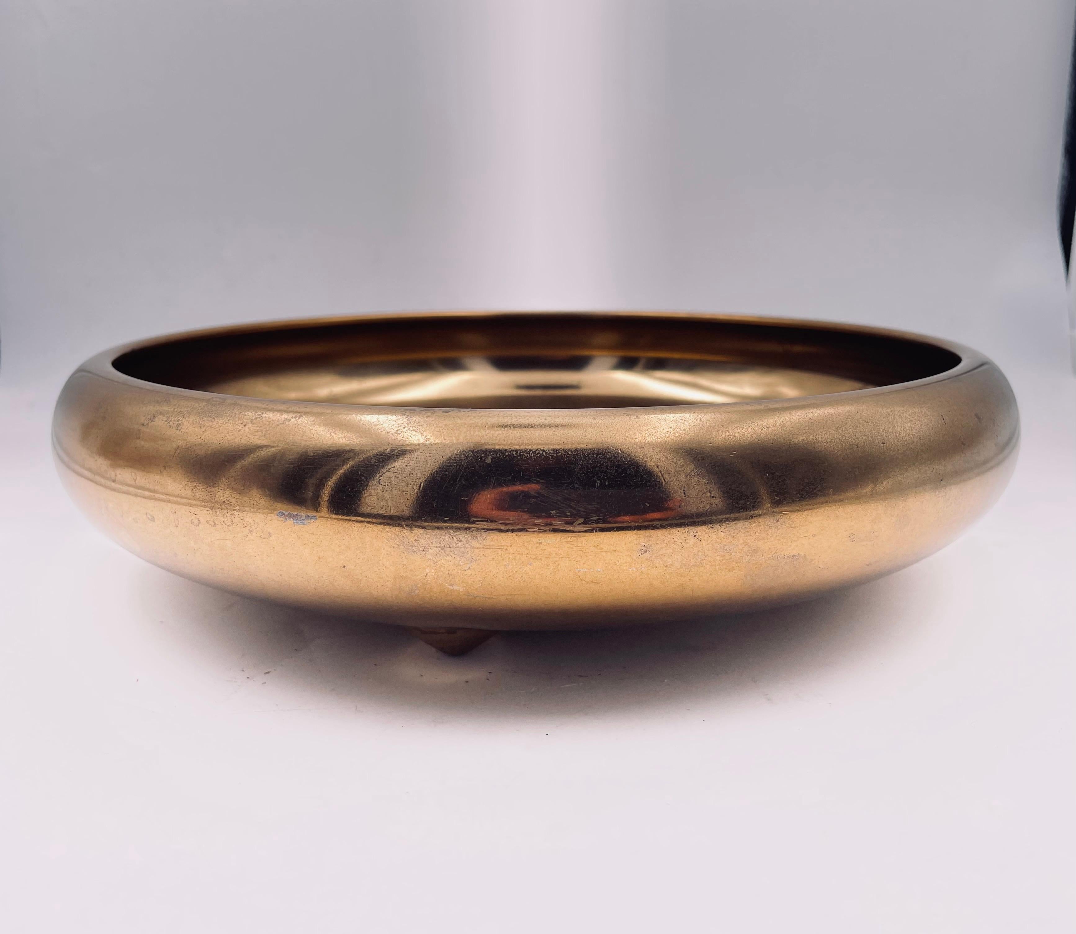 Beautiful solid polished brass catch it all bowl, by Zeiglier nice niple feet well done heavy signed at the bottom some tarnish due to normal wear but can be polished.