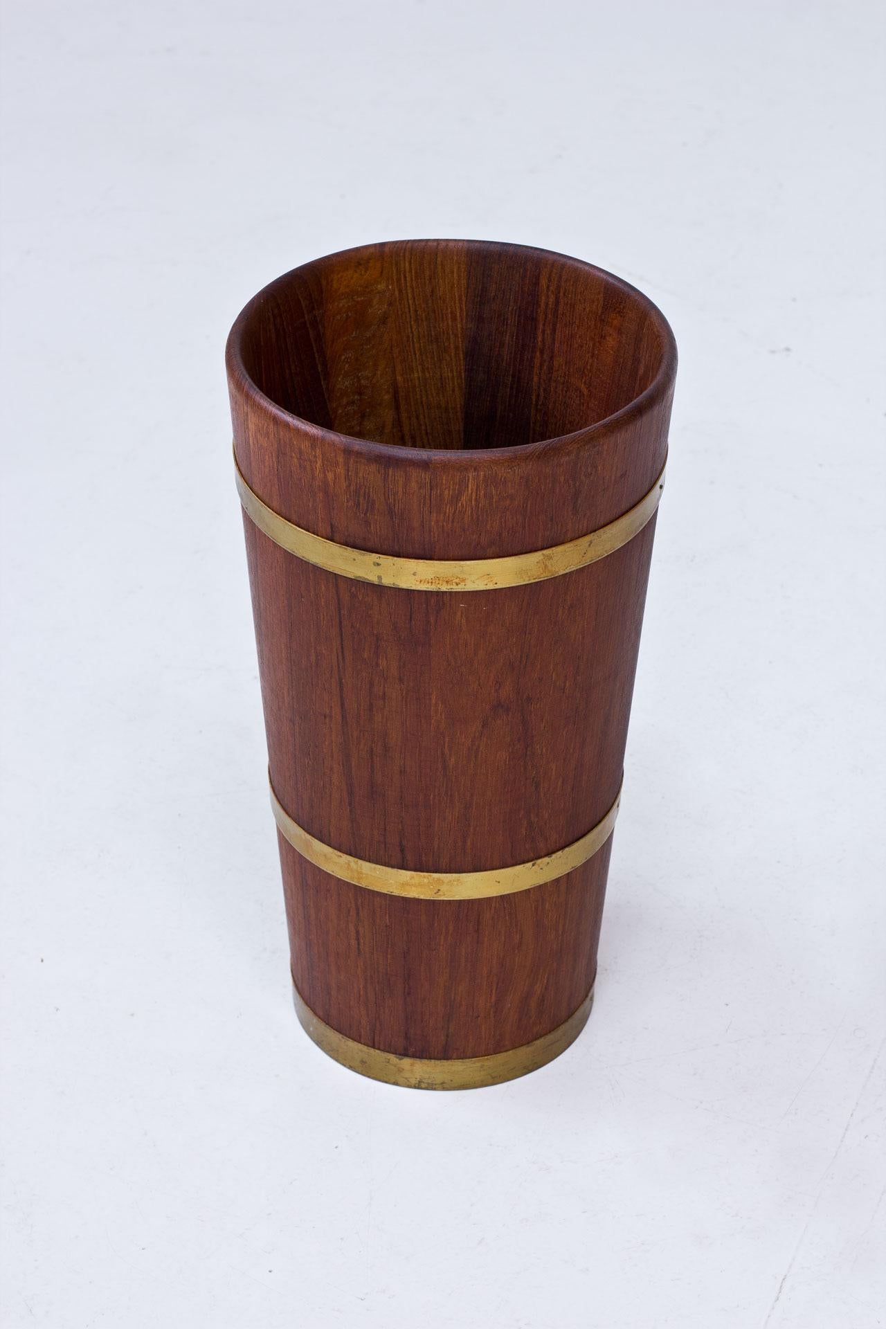 1950s umbrella stand, manufactured in Sweden. Solid teak with brass rings.
Useful as a paper basket.