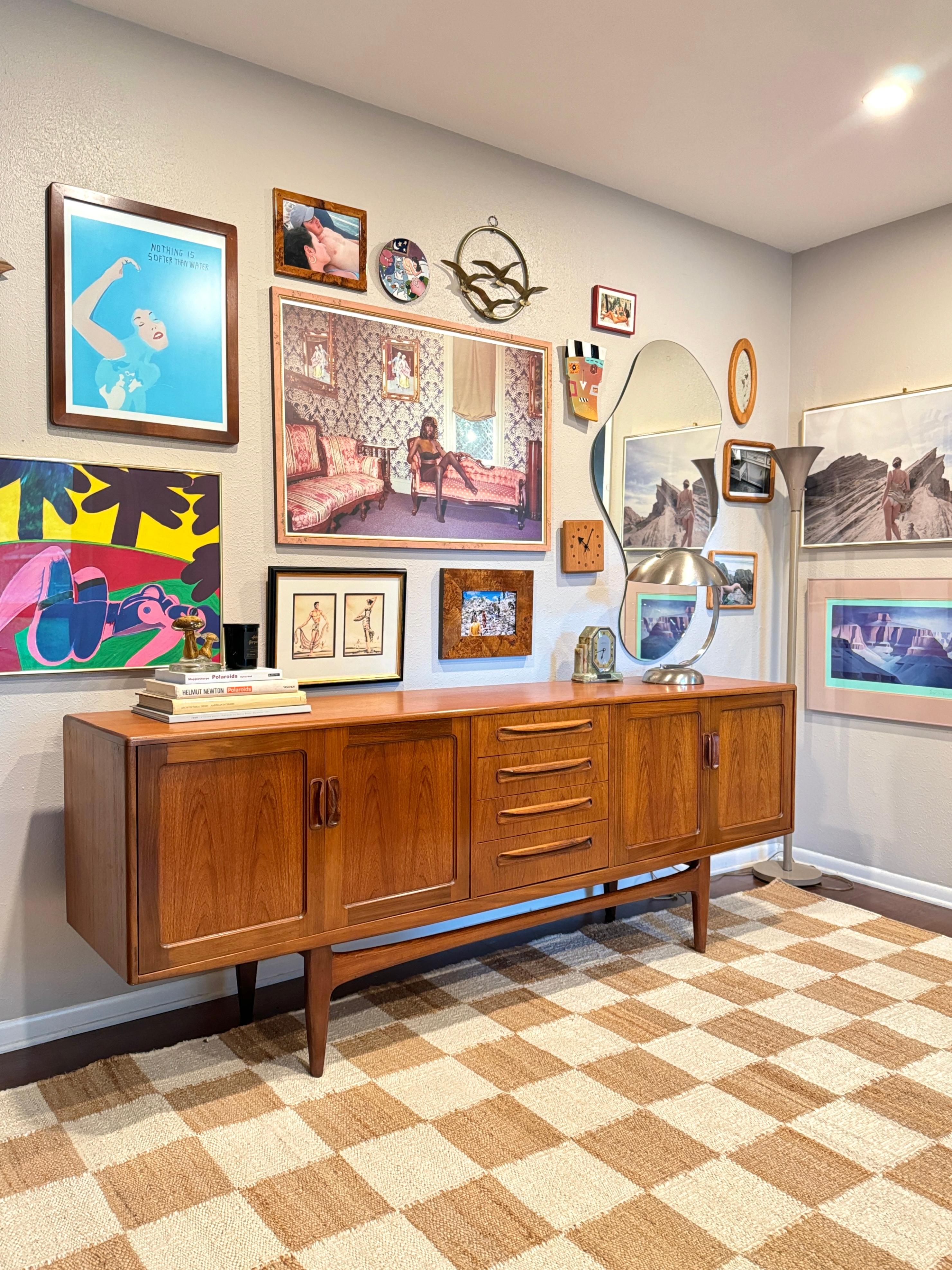 Mid Century Modern solid teak Fresco sideboard by G Plan. The center of the sideboard has a central bank of four drawers with two doors to either side. Has a stretcher below and raised on tapered legs. This was the Rolls Royce of sideboards in the