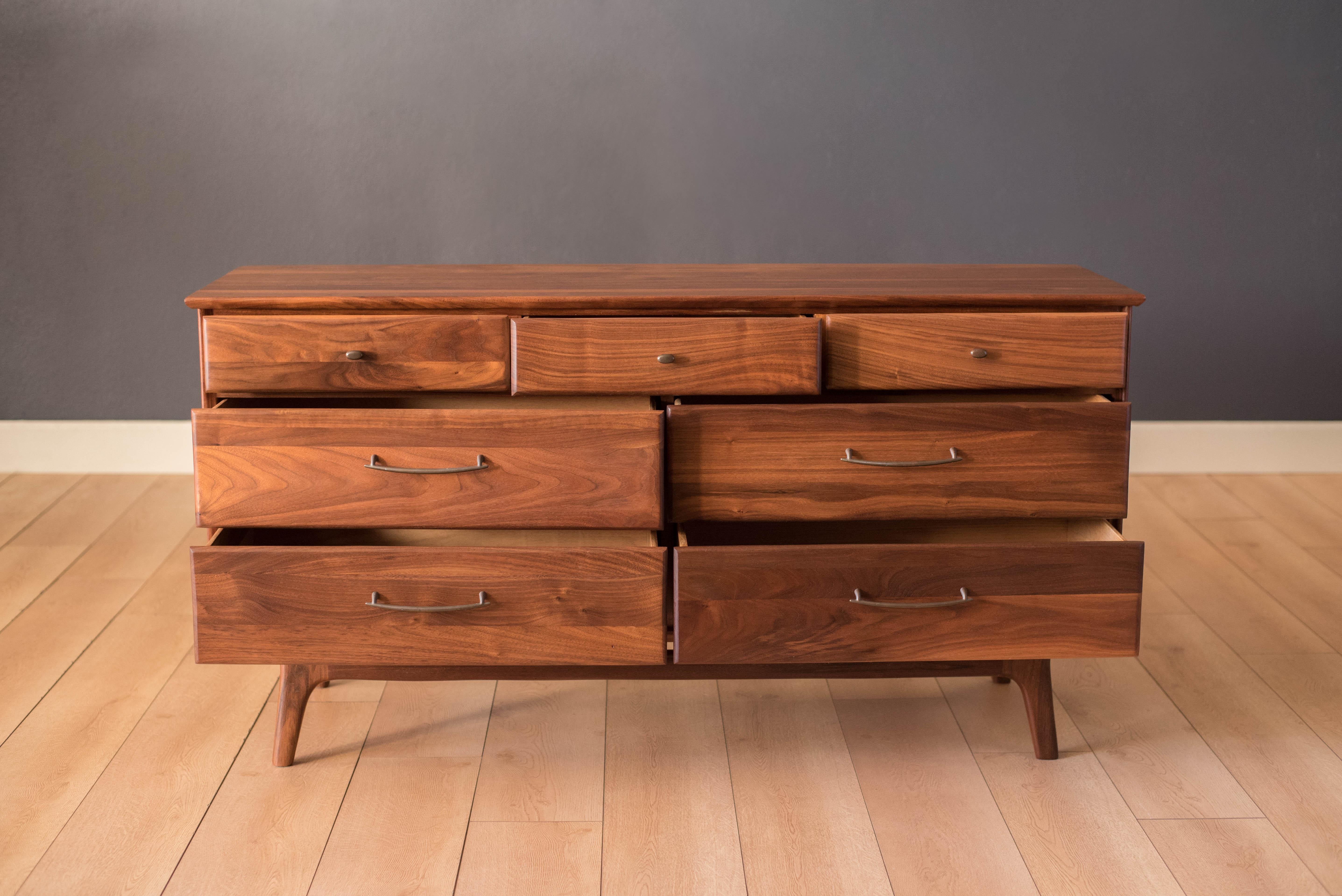 Vintage prelude dresser for ACE-HI Furniture in solid planked walnut. This piece offers plenty of storage and includes seven drawers accessorized with pewter pulls.





 