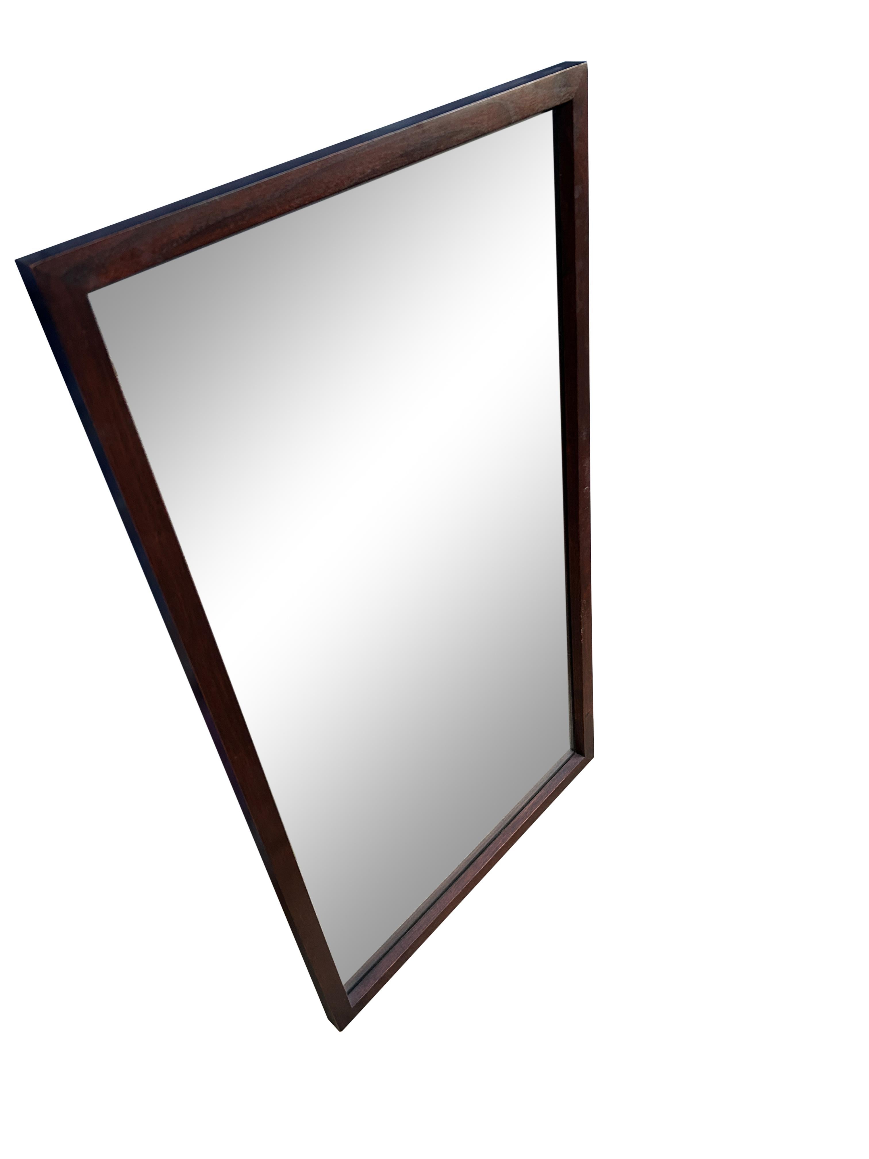 Mid-Century Modern solid walnut framed wall mirror. Currently wired ready for use. Rectangle mirror frame. Wood backing very good construction.

Measures 20” x 36” x 1