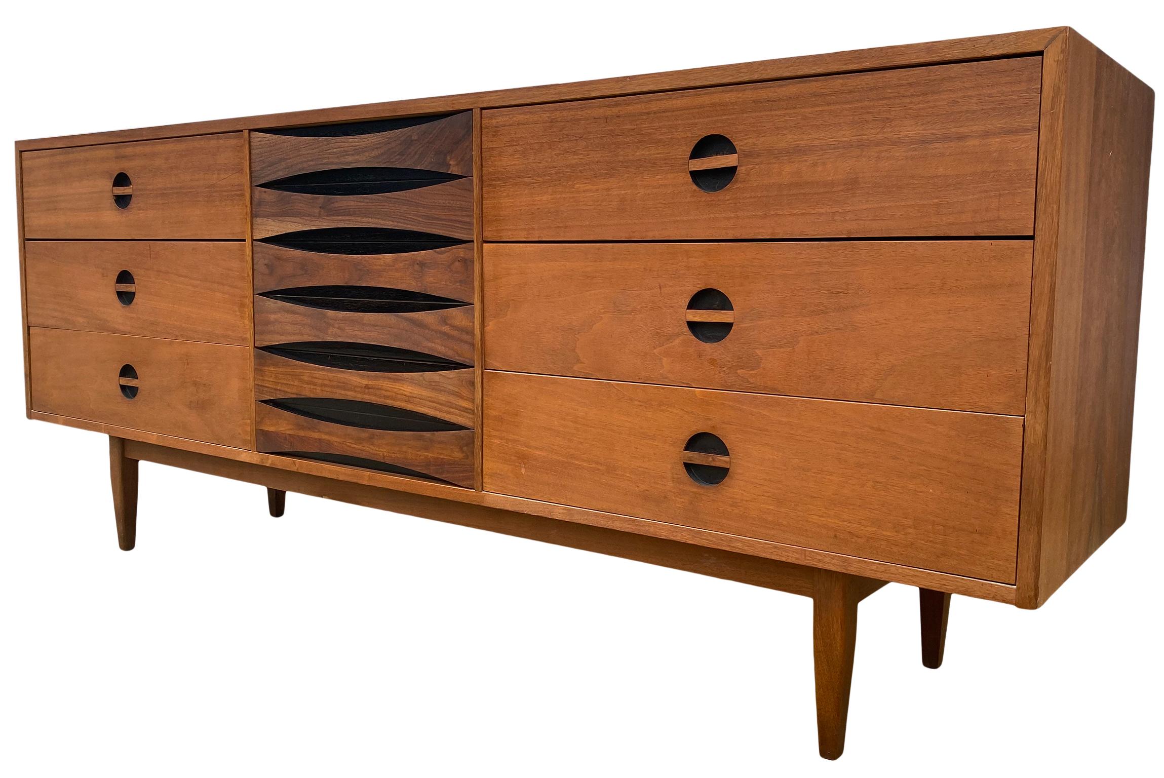 An exceptional long low Mid-Century Modern Arne Vodder style walnut 9-drawer dresser credenza by West Michigan Furniture Co. The dresser features beautiful walnut wood grain with sculpted recessed drawer pulls. It offers ample storage, with nine