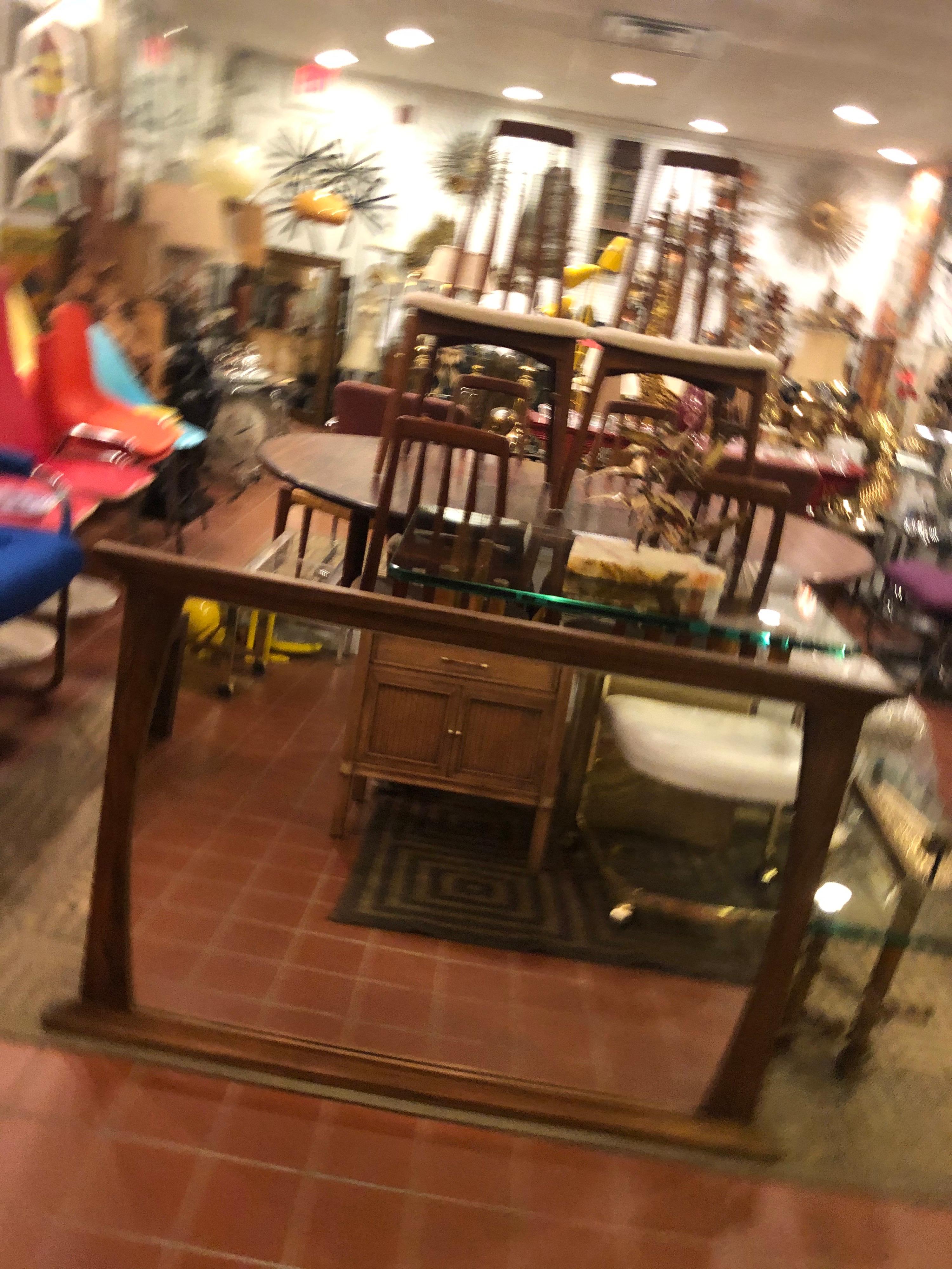 Mid-Century Modern solid walnut mirror. Can be hung horizontally or vertically. Interesting shape, Brutalist style.
We can offer dealer white glove delivery which is more economical than 1stdibs shipping. Please inquire with a zip code.