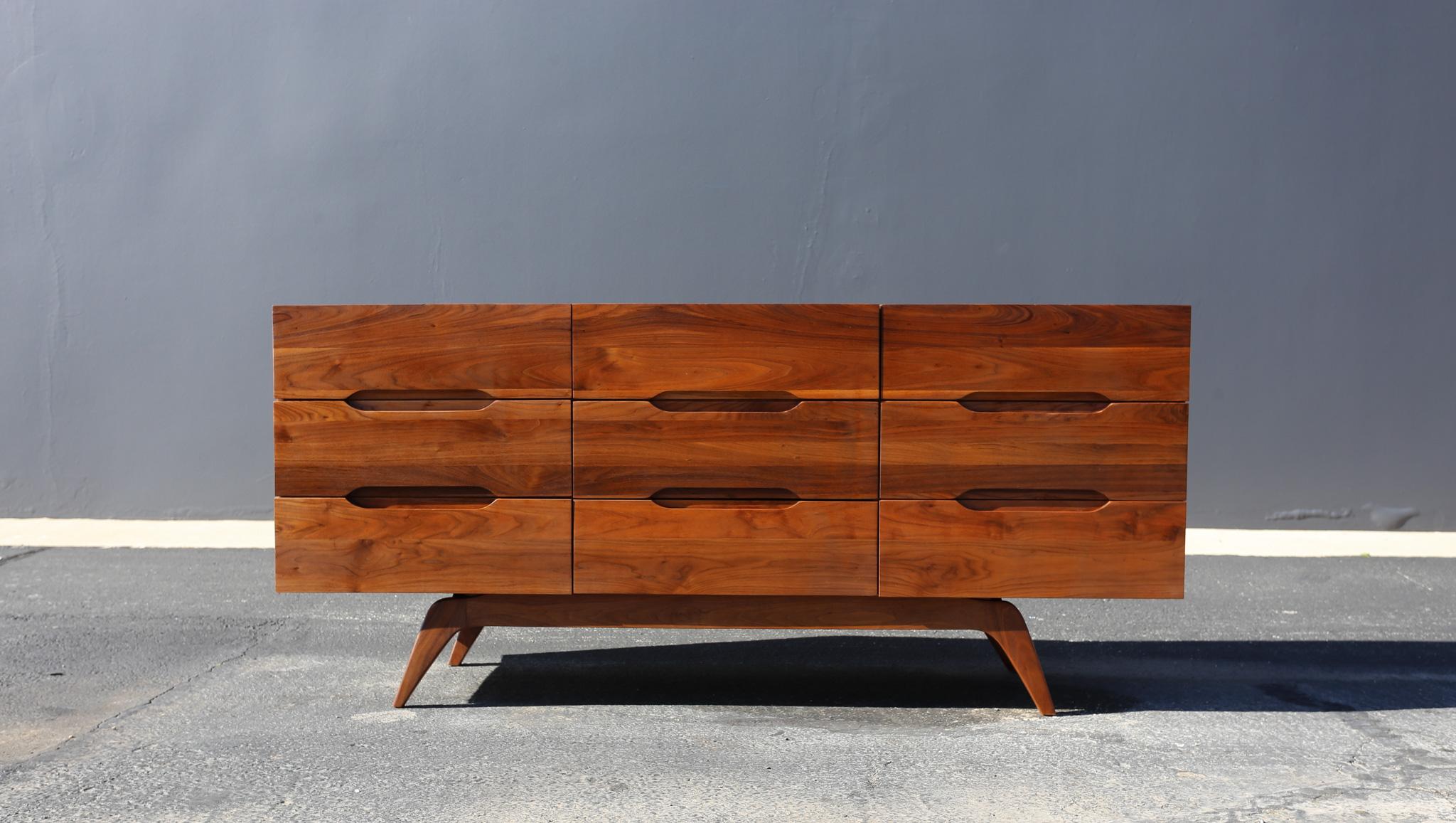 Mid Century Modern Solid Walnut Sculpted Nine Drawer Dresser, USA, 1960's.  This piece has been professionally restored.  
