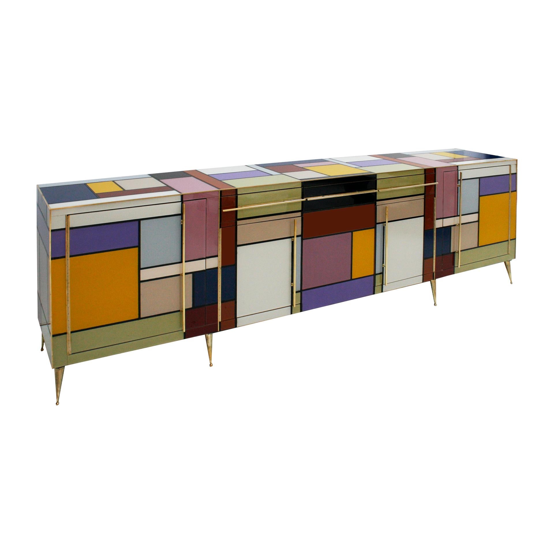 Sideborad comoposed of 3 drawers and 4 doors with original 1950s solid wood sturcture covered in colored glass. Handles, profiles and legs made of brass. Italy.

Production can last between 5 and 6 weeks.

Our main target is customer satisfaction,
