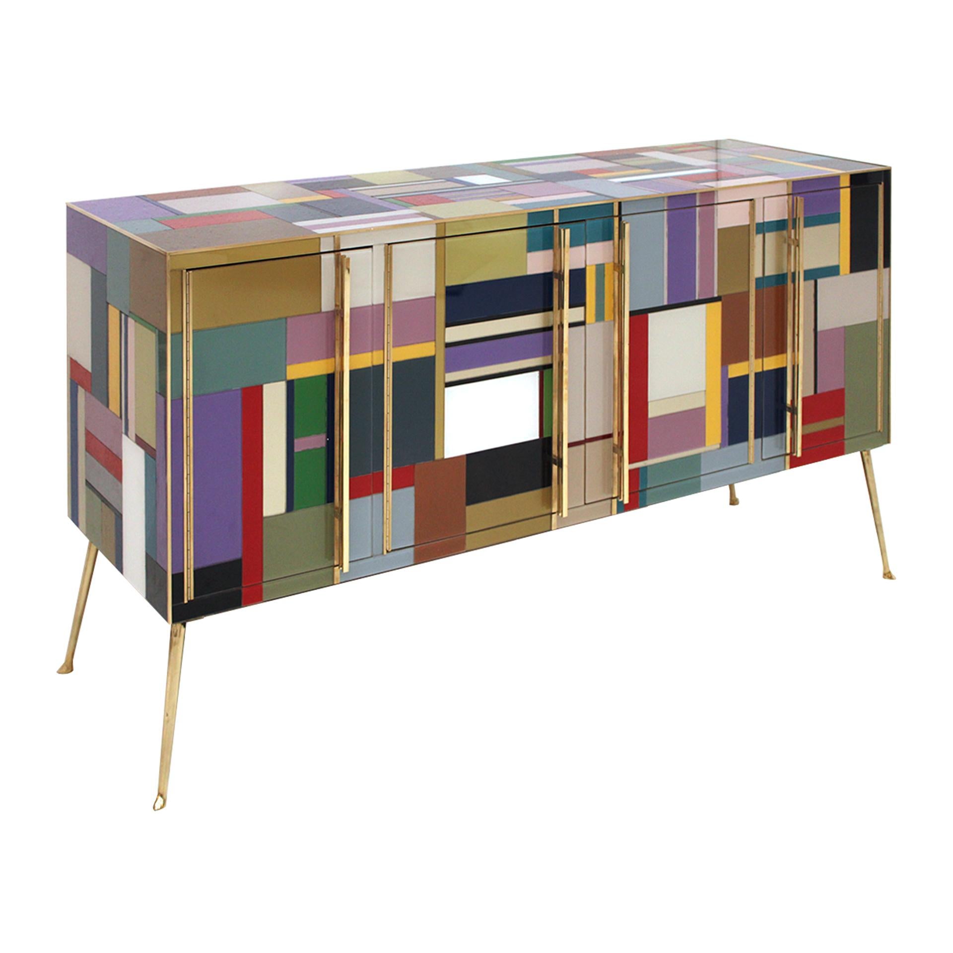 Mid-century sideboard, newly retrofitted in contemporary Murano glass. Comoposed of 4 doors with original 1950s solid wood sturcture covered in colored glass. Handles, profiles and legs made of brass. Italy.

Production can last between 5 and 6