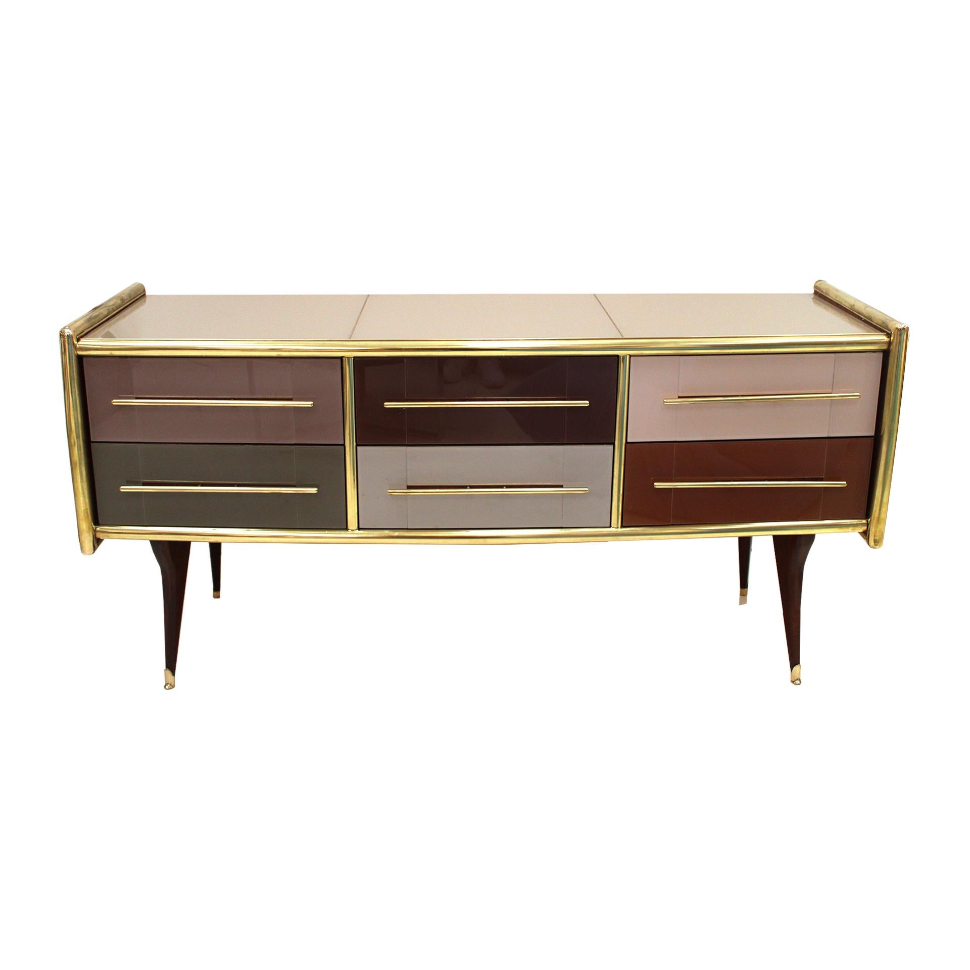Sideborad comoposed of 6 drawers with original 1950s solid wood sturcture covered in colored glass. Handles, profiles and legs made of brass. Italy.

Our main target is customer satisfaction, so we include in the price for this item professional