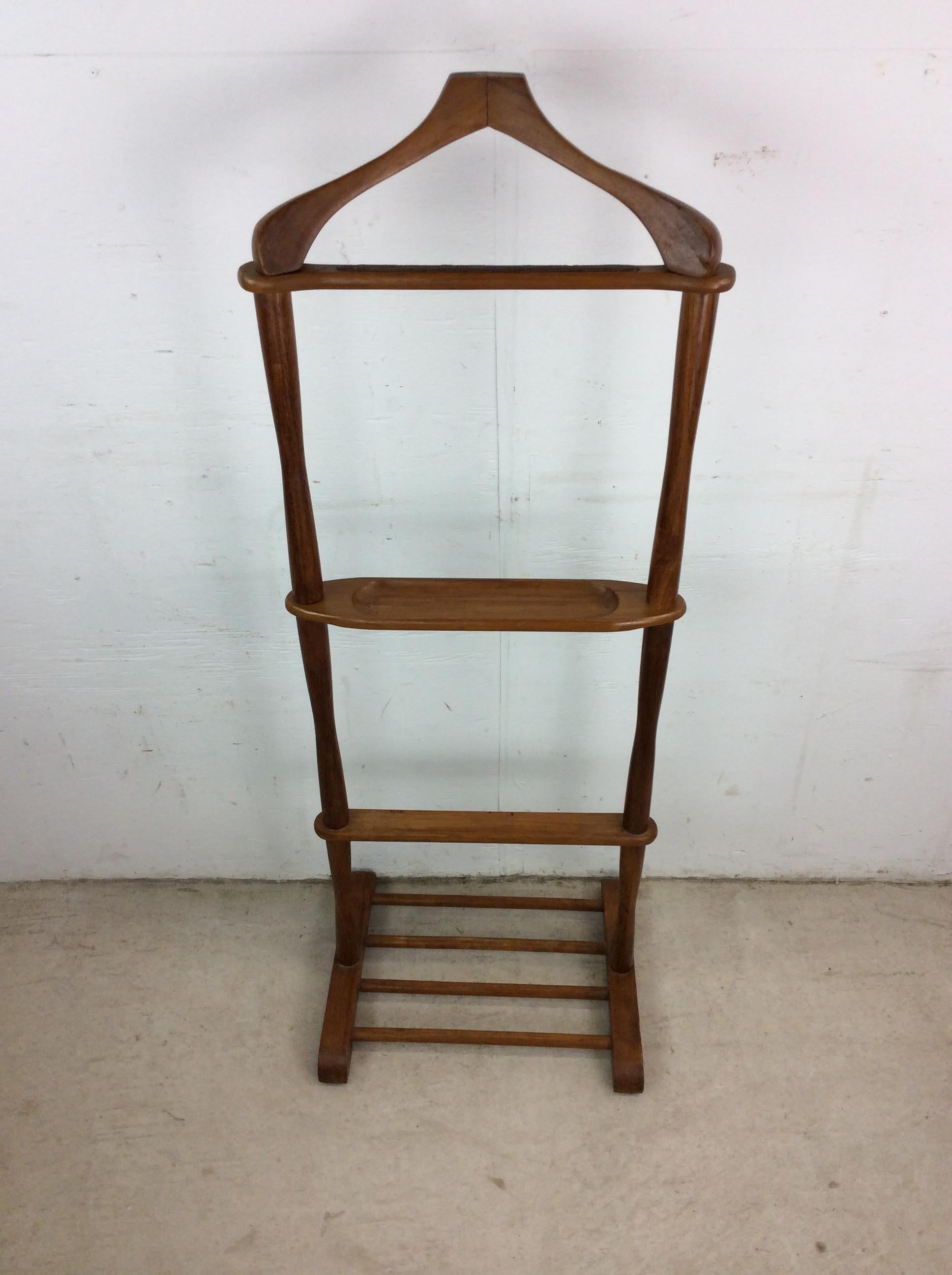 This mid century modern gentleman’s valet features hardwood construction, original walnut finish, sculpted hanger like coat rack, and carved wood accessories dish. 

Dimensions: 18w 14d 48.5h

Condition notes: Original finish is in good condition.
