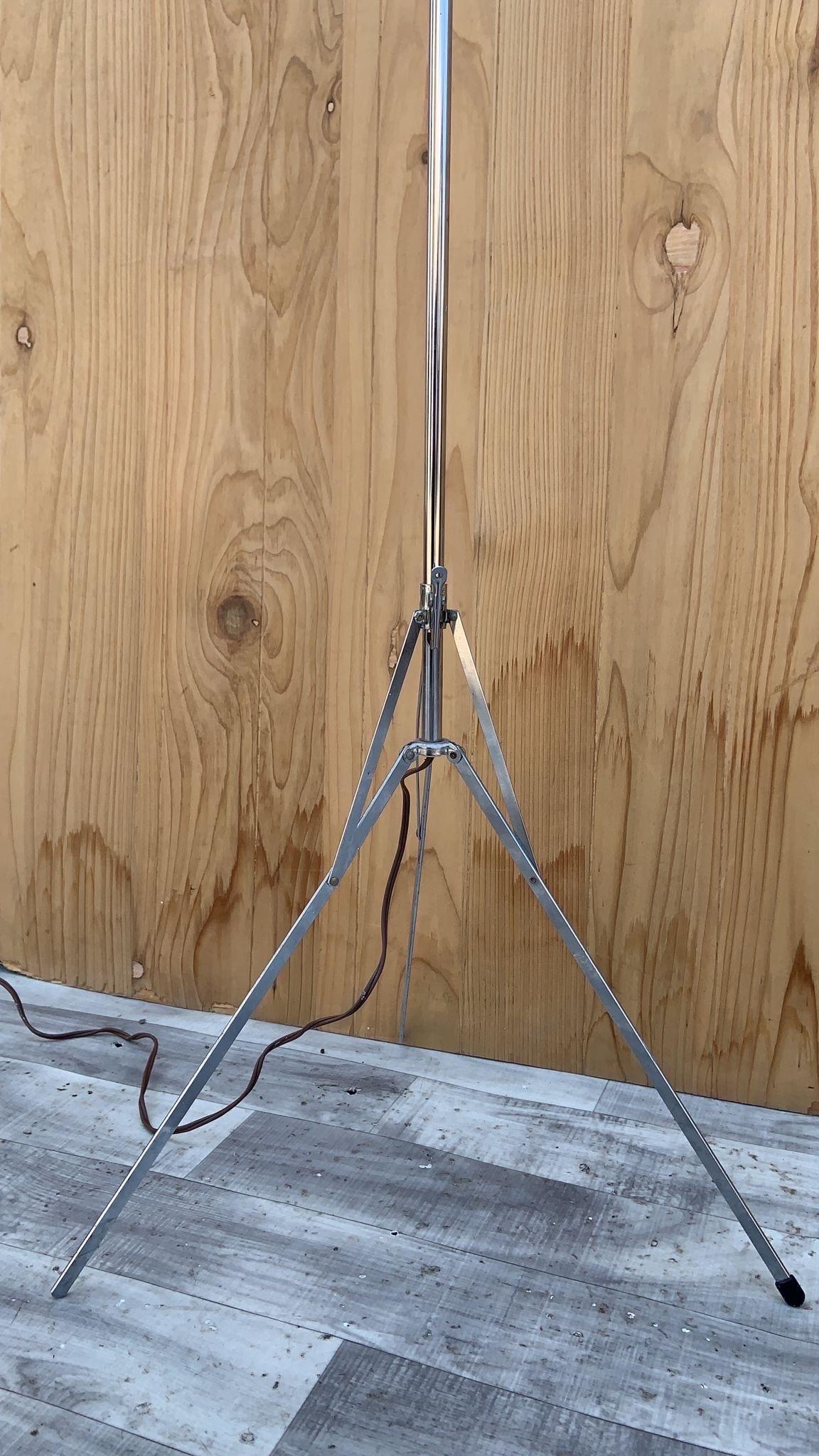 Mid Century Modern Space Age Extending Chrome Tripod Floor Lamp

A mid century modern adjustable atomic style tripod floor lamp with its original chrome finish. The head of the lamp can be tilted to adjust the angle of the light.

Circa