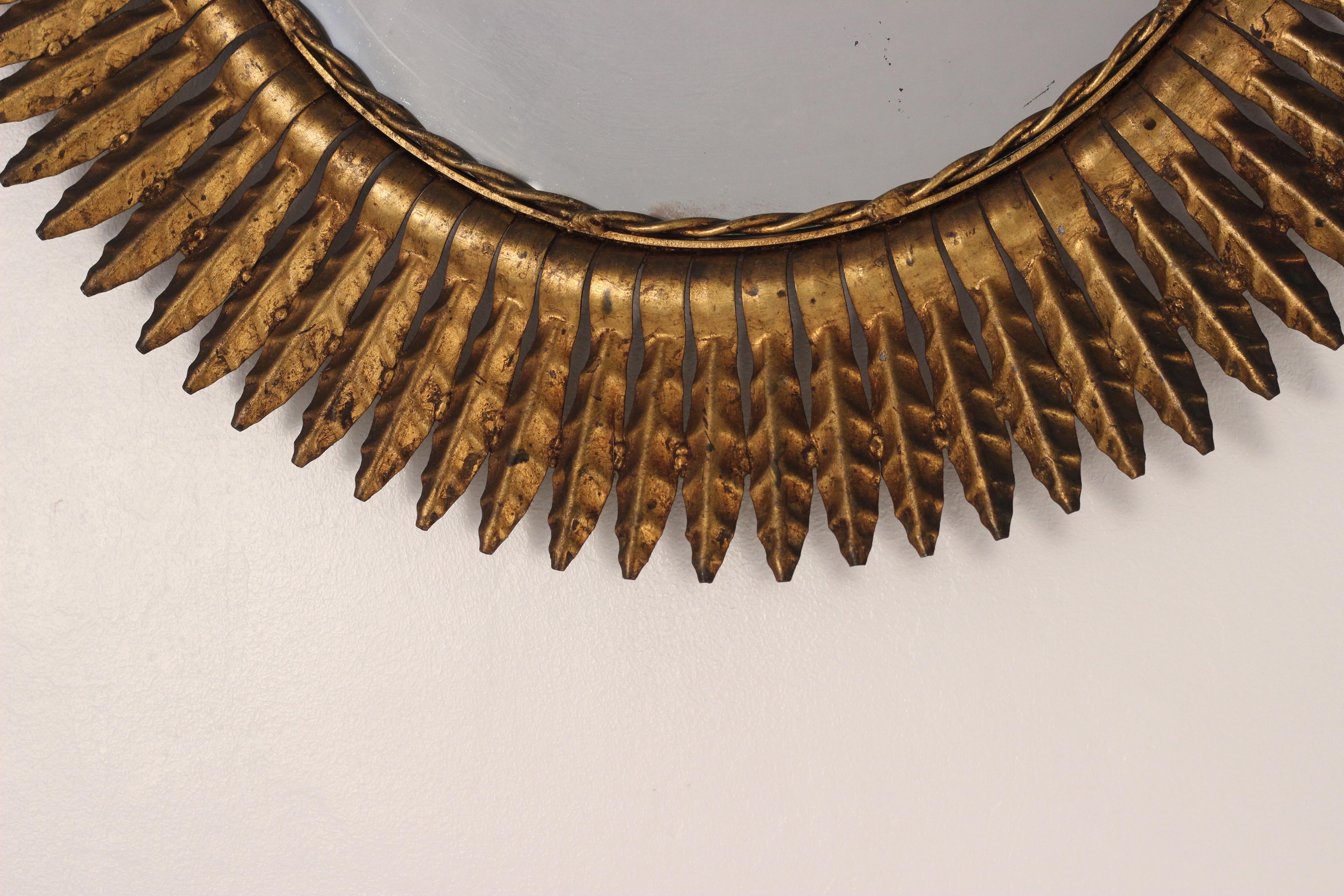 A Mid-Century Modern Gilt Hollywood Regency style Spanish Sunbeam 1950’s mirror. Would not look out of place in a Boho Chic Style layered interior, surrounded by ethnic and other artesian pieces.