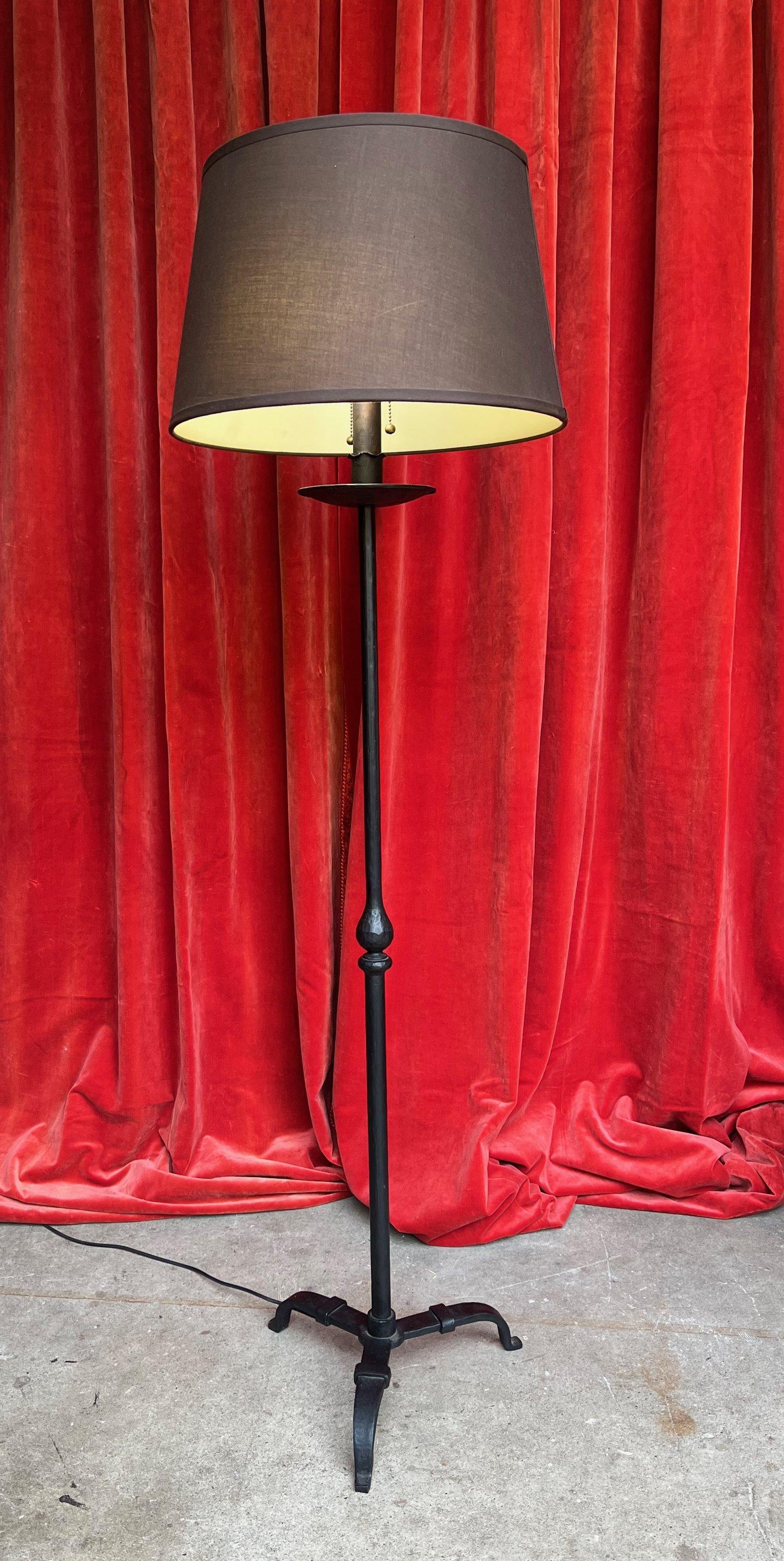 A unique and elegant mid-century modern Spanish iron floor lamp that perfectly blends style and functionality. Hand made in the 1950s, this exceptional piece boasts excellent quality and timeless appeal. Standing at 62 inches high with a 14½ inch