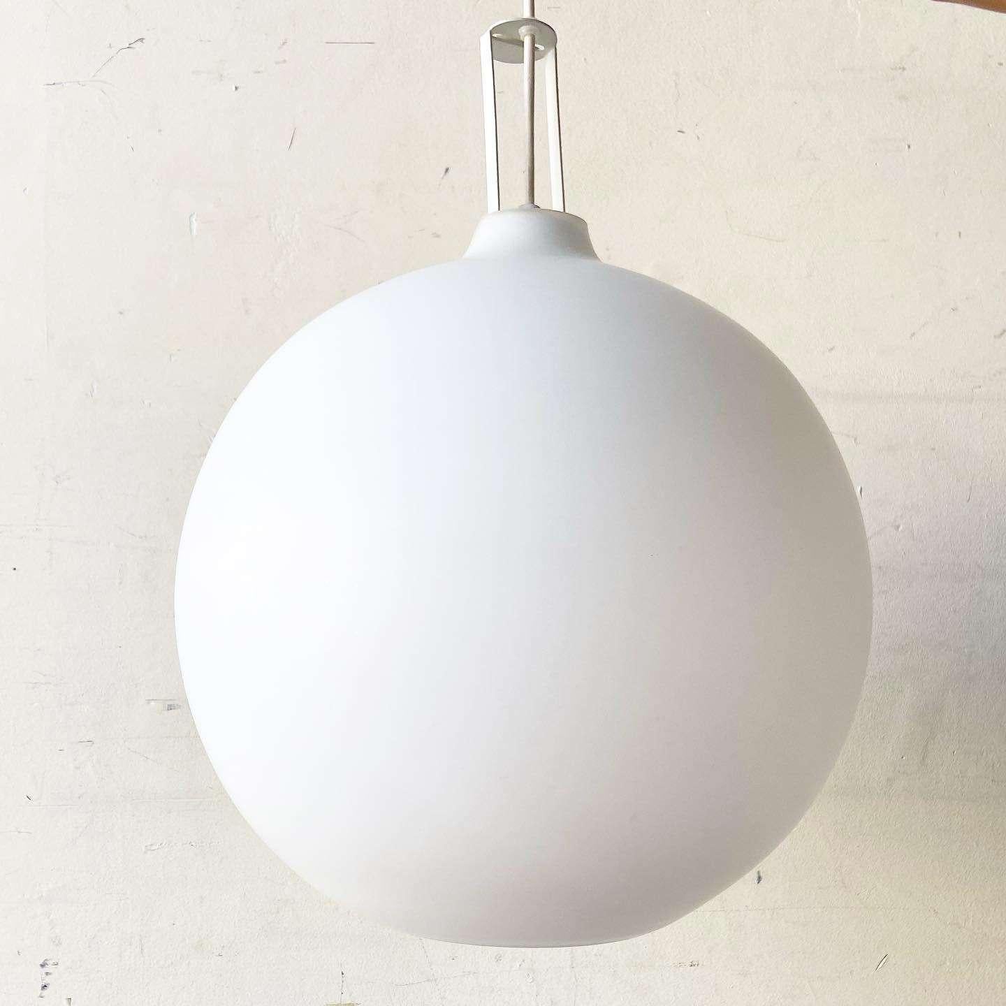 Incredible vintage mid century modern pendant lamp. Features a wonderful smooth white spherical shape.