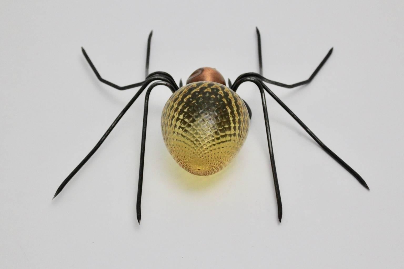 Mid Century Modern vintage wall lamp or sconce spider shape 1950s, Italy.
A gorgeous sconce from metal and glass. 
The legs were made of metal wire, while the body was made of yellow grooved glass and copper.
OneE 14 socket.
This lighting works