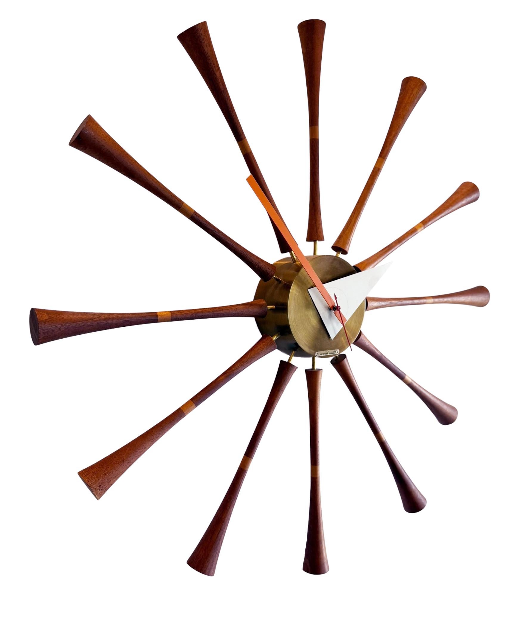 Early and original spindle clock designed by George Nelson for Howard Miller Clock Company. It features solid wood spindles with brass numberless dial. Tested and working as it should.