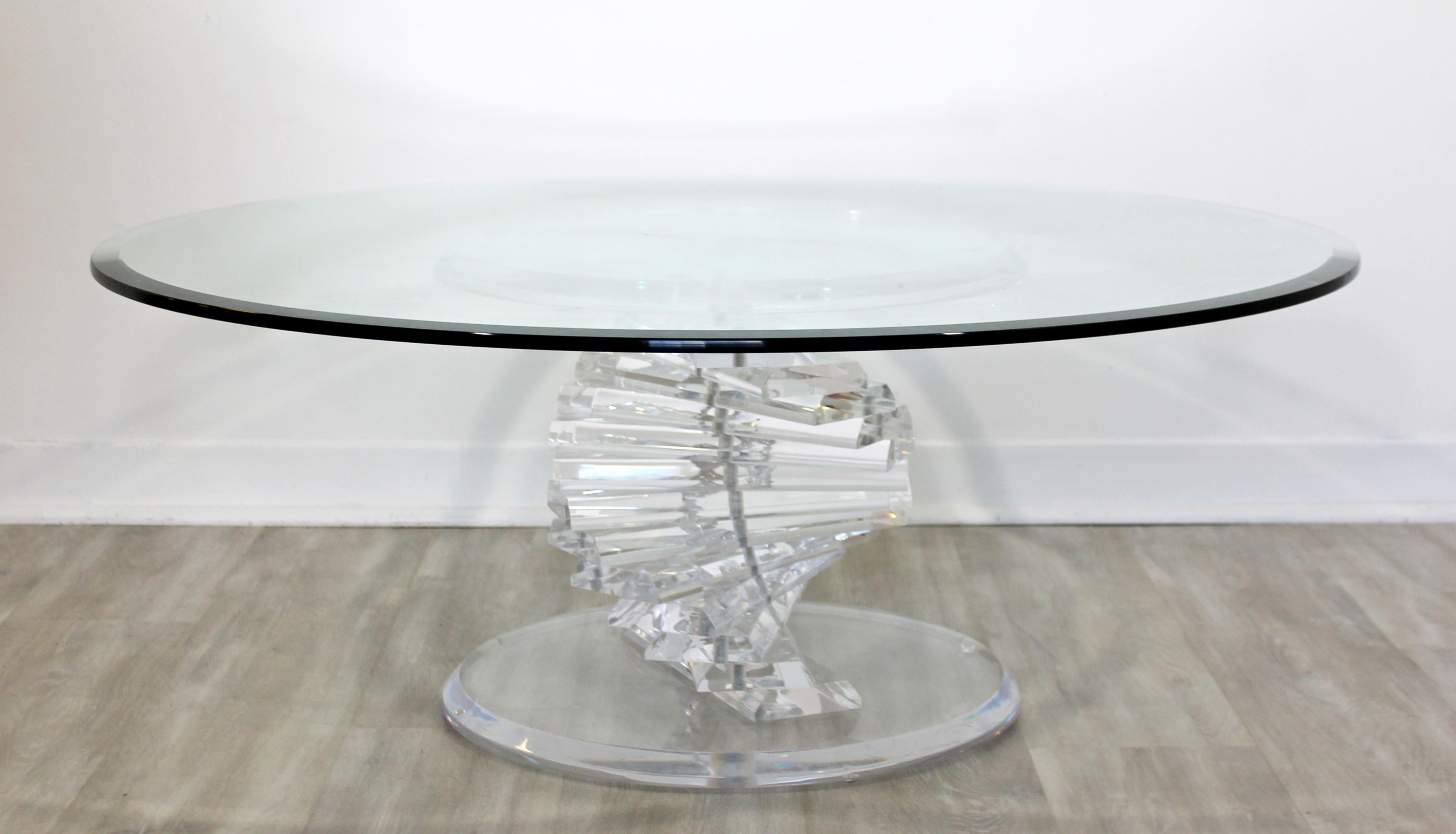 For your consideration is a simply stunning, round glass topped coffee table, on a spiral helix Lucite base, circa 1970s. In excellent vintage condition. The dimensions are 42