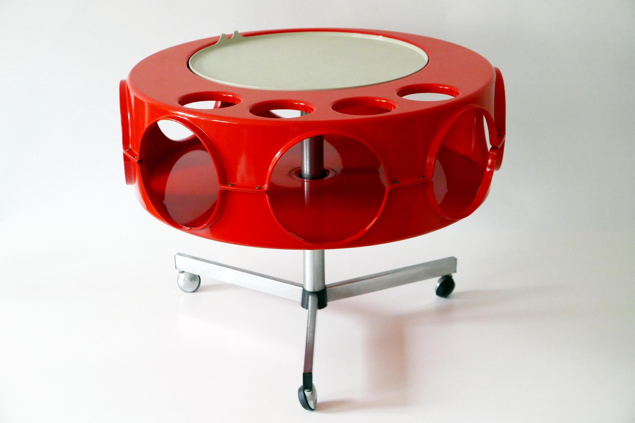 Iconic Mid-Century Modern Pop Art bar cart or bar table 'Ufo'. Manufactured by Curver, 1970s, Netherlands.

Executed in dark red and gray colored ABS plastic and chrome-plated metal base on wheels, this iconic piece of 1970s Pop Art design is a