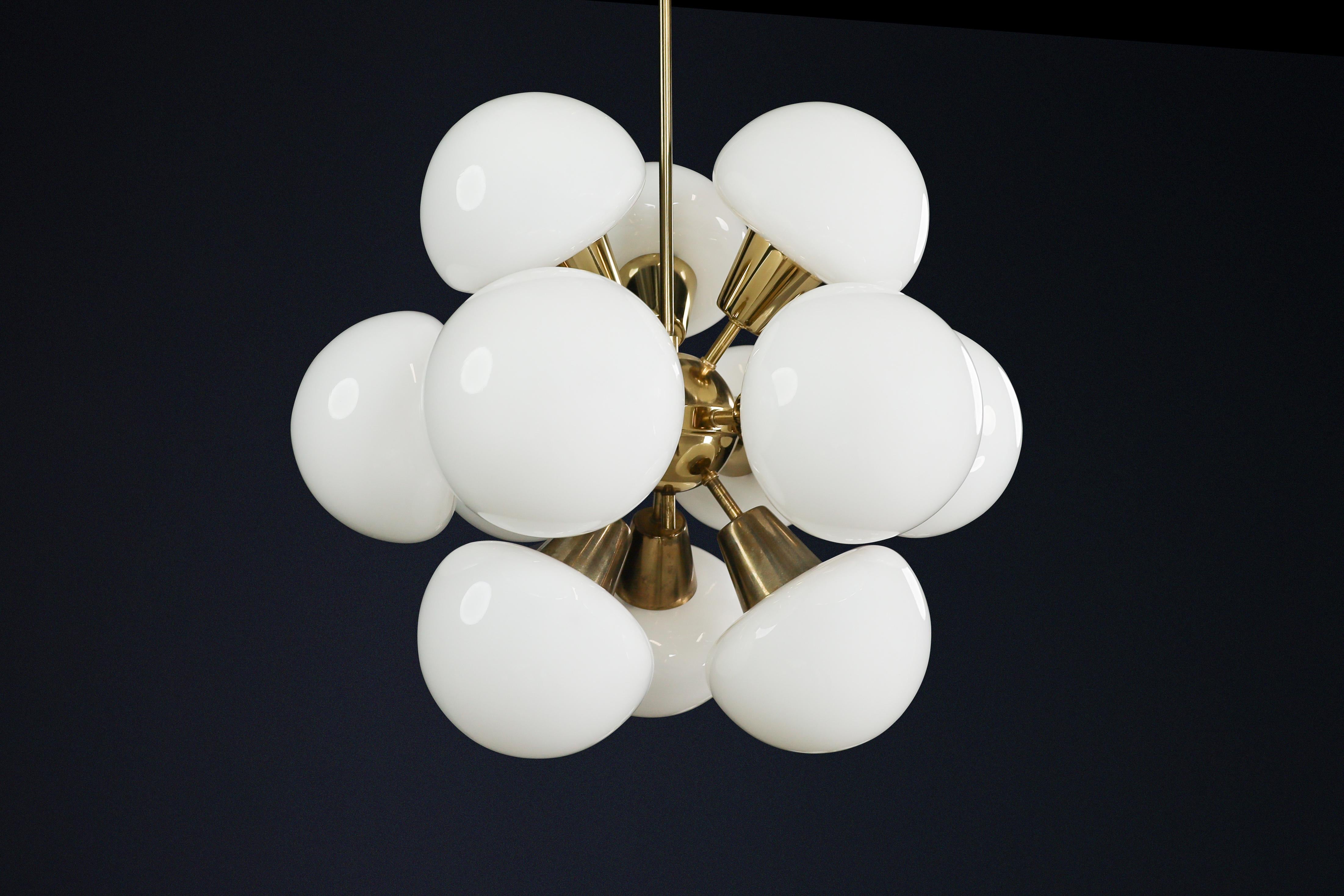 Lustre Sputnik Modern en laiton et verre opalin, République tchèque, 1970

Exemple frappant du design de l'Europe de l'Est des années 1970, ce lustre Sputnik Modern du milieu du siècle présente un arrangement sculptural de douze sphères en verre
