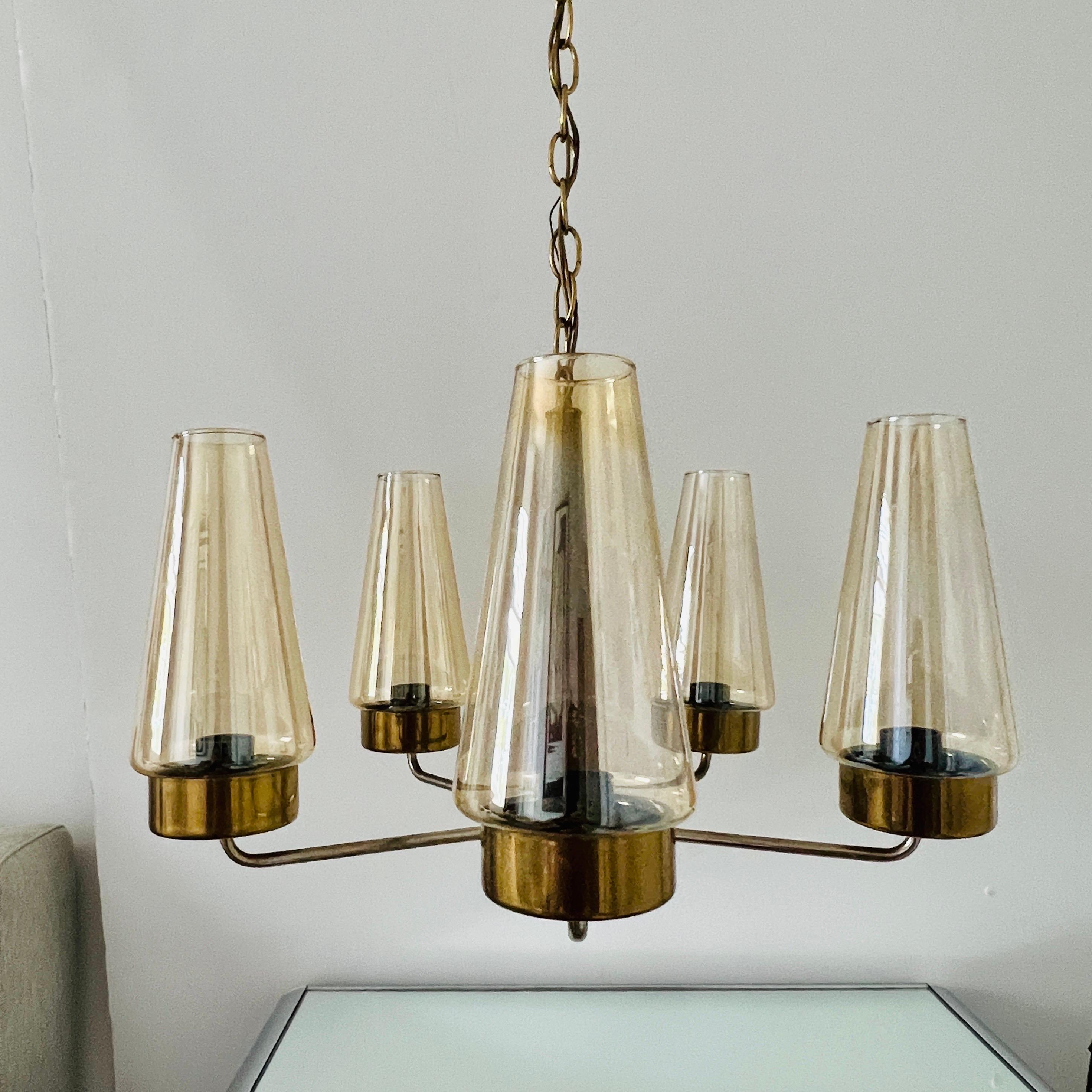 Danish Mid-Century Modern chandelier with teak wood stem, chrome and brass metal, and fitted with five lights.  The chandelier features blown glass hurricane shades in iridescent bronze or amber hues. Adjustable chain allows for desired height.