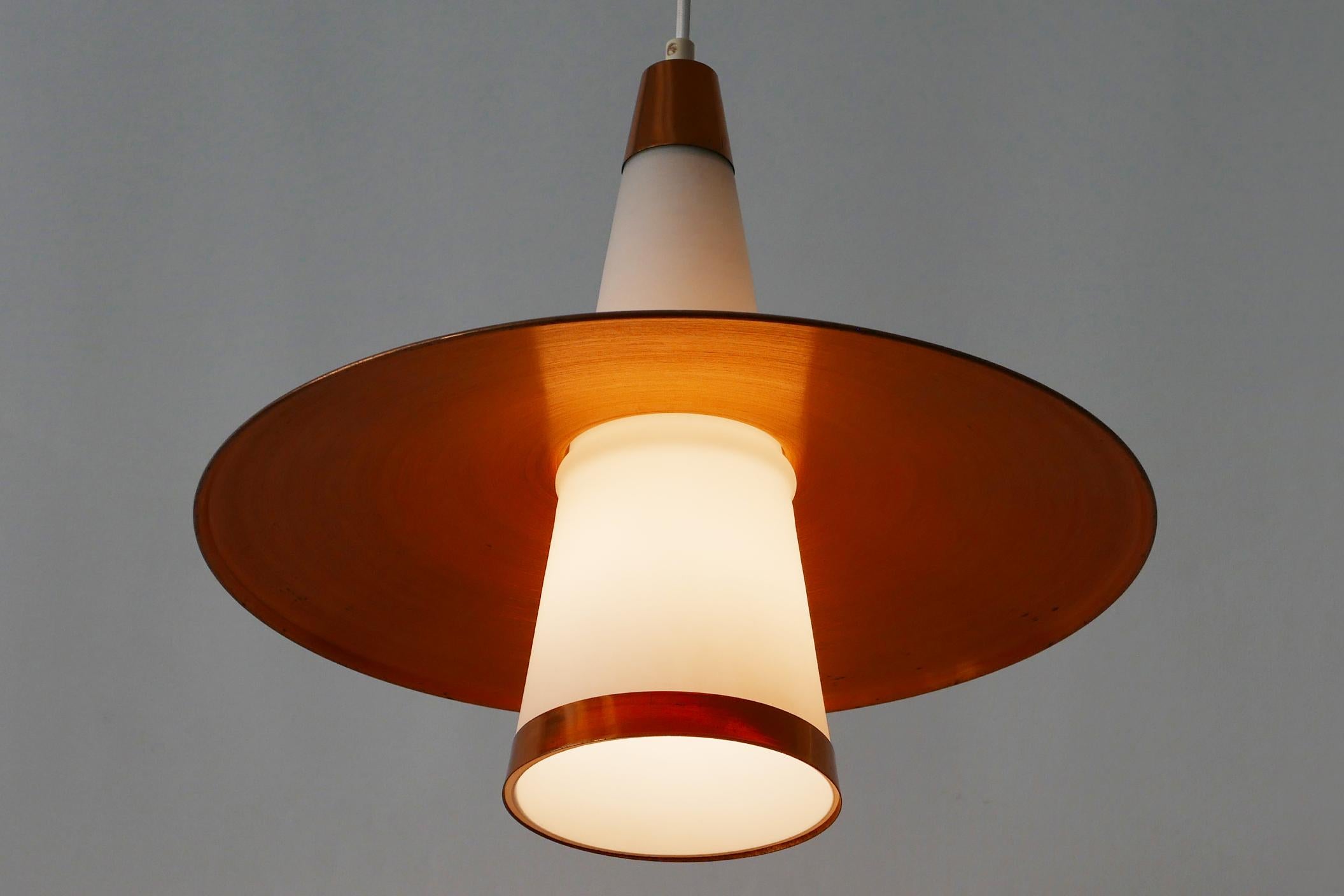 Exceptional and elegant Mid-Century Modern Sputnik copper and opaline glass pendant lamp or hanging light in form of an UFO. Designed and manufactured probably in 1950s, Denmark.

Executed in copper sheet and opaline glass, the pendant lamp needs 1