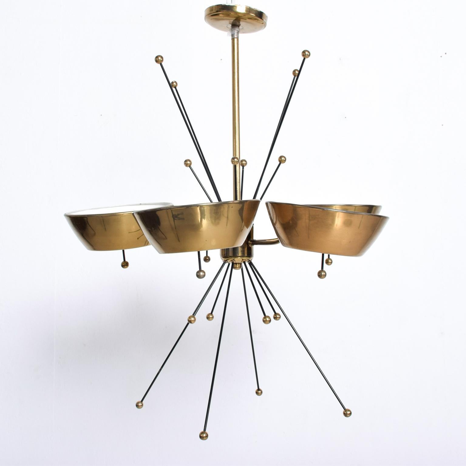 We are pleased to offer for your consideration a beautiful chandelier made in Italy, circa the 1960s. Brass with glass and iron rods. Sputnik style. Unmarked, no information present on the maker. Attributed to Paavo Tynell based on style.