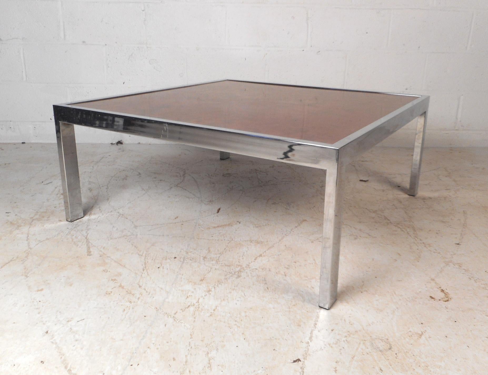 This beautiful vintage modern coffee table features a faux burl top with a heavy chrome frame. A fabulous straight line design with a stunning patterned top and chrome legs. This stunning midcentury table  makes the perfect eye-catching addition to