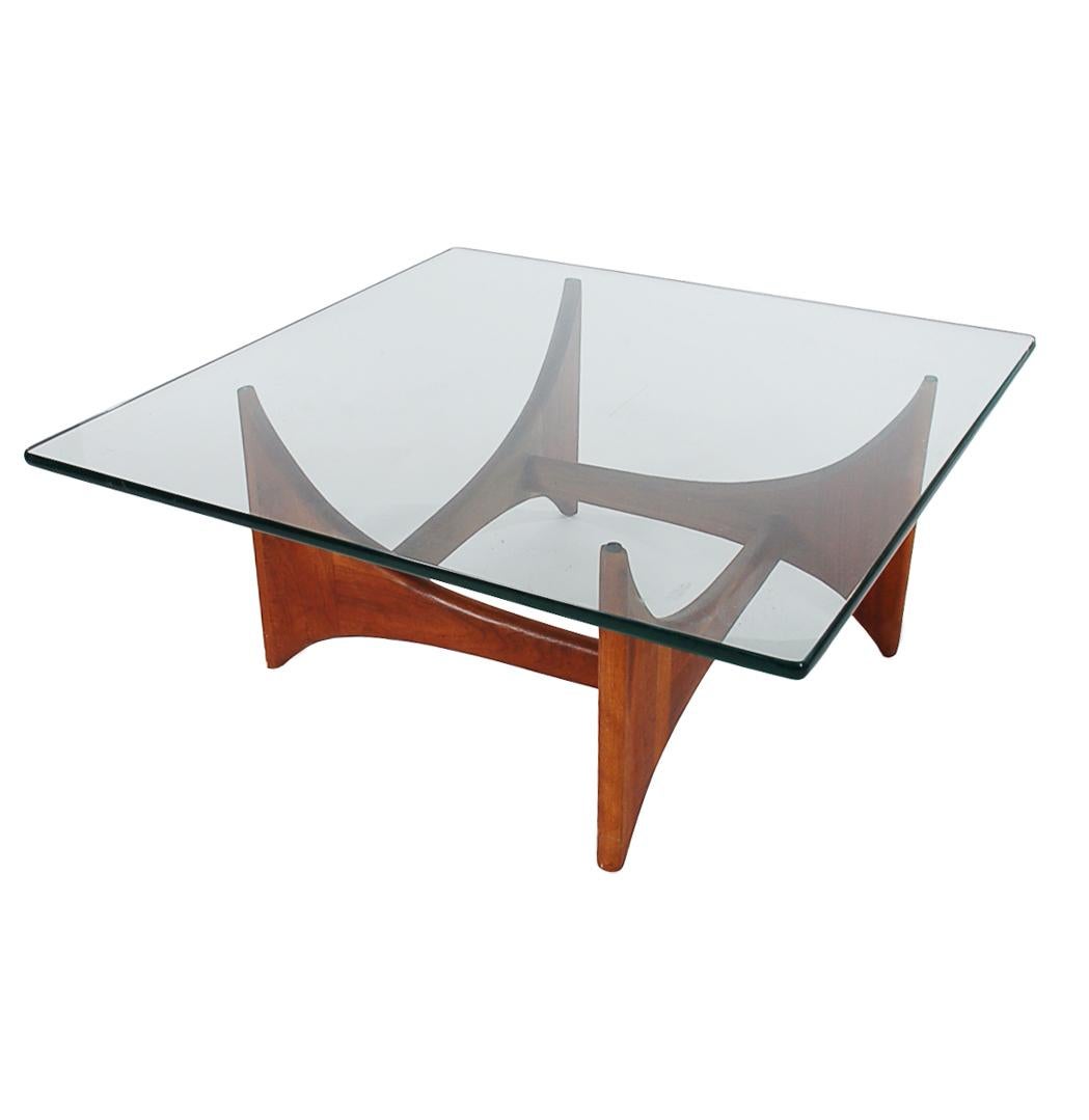Handsome and smaller scale coffee table designed by Adrian Pearsall for Craft Associates in the 1960s. This table features a solid walnut base with a thick clear glass top.