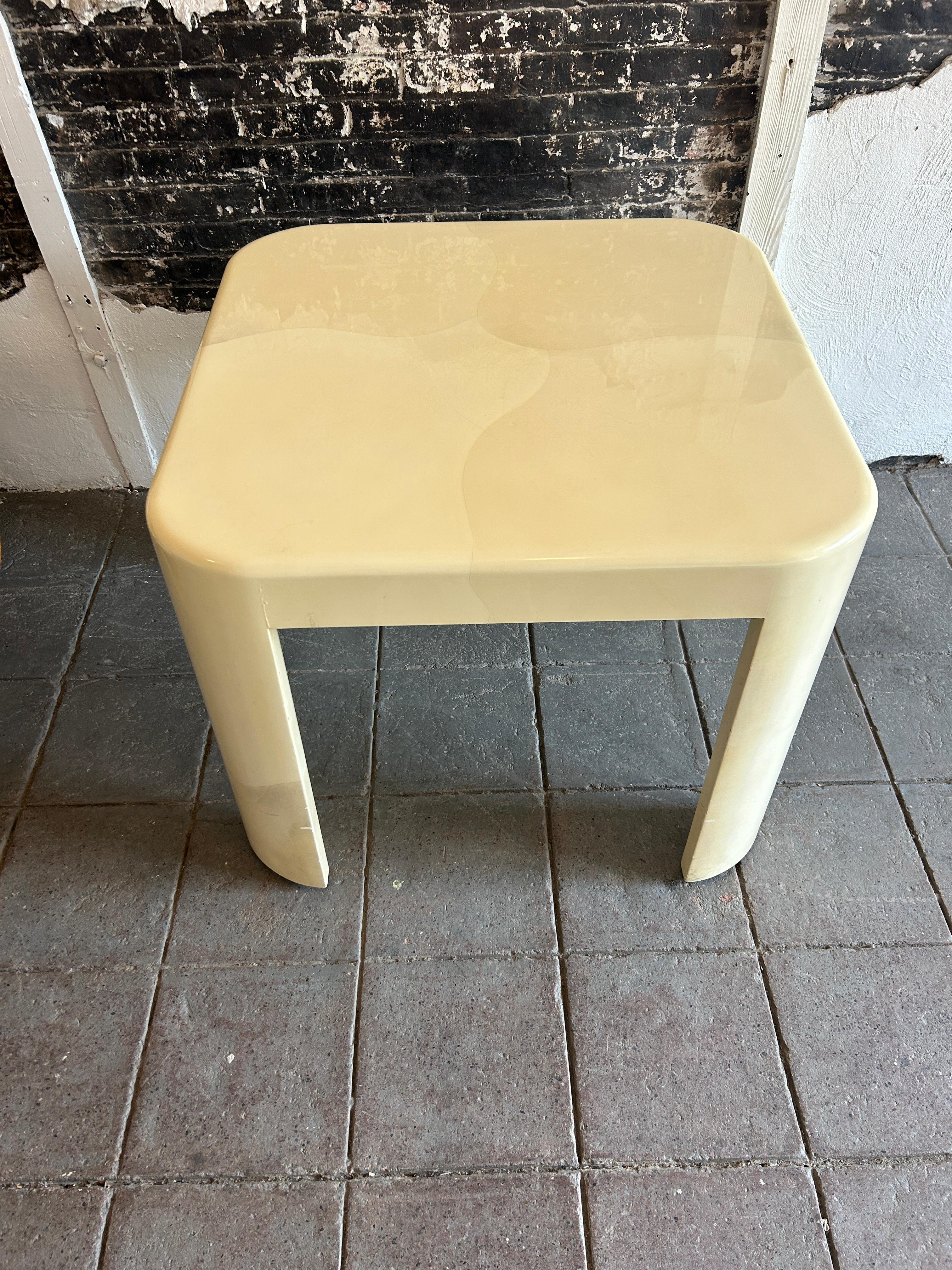 Rare Mid-Century Modern cream colored sculptural dining or game table with half cylindrical rounded legs and thick lacquered top with Tri color circular pattern design on top surfaces by Karl Springer. C. 1980. High gloss finish light wear to top