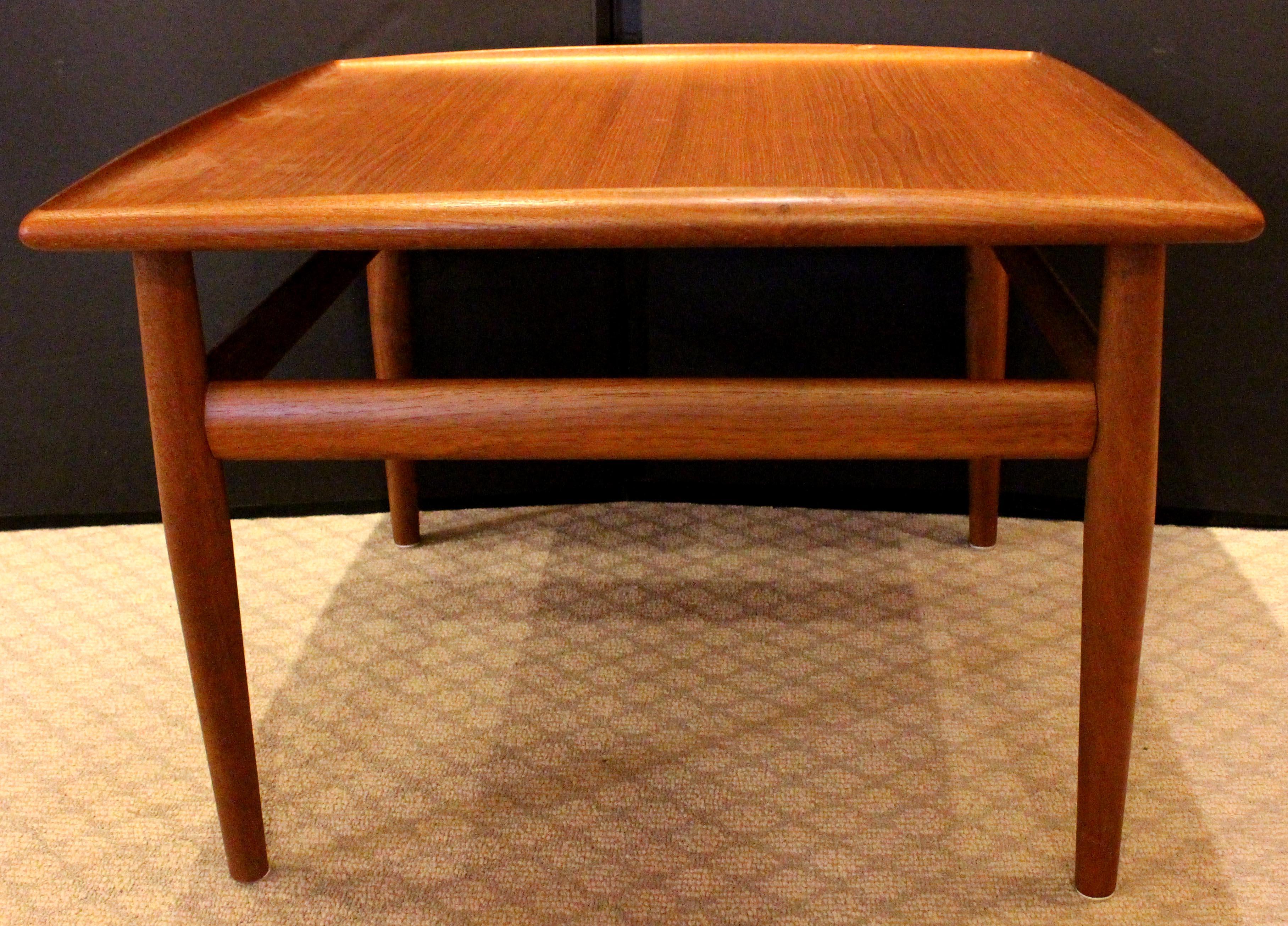 Mid Century Modern square side or coffee table, c.1960s. Designed by Greta Jalk for Glostrup of Denmark. Solid teak with teak veneered surface. Upswept edges. One minor 3/4