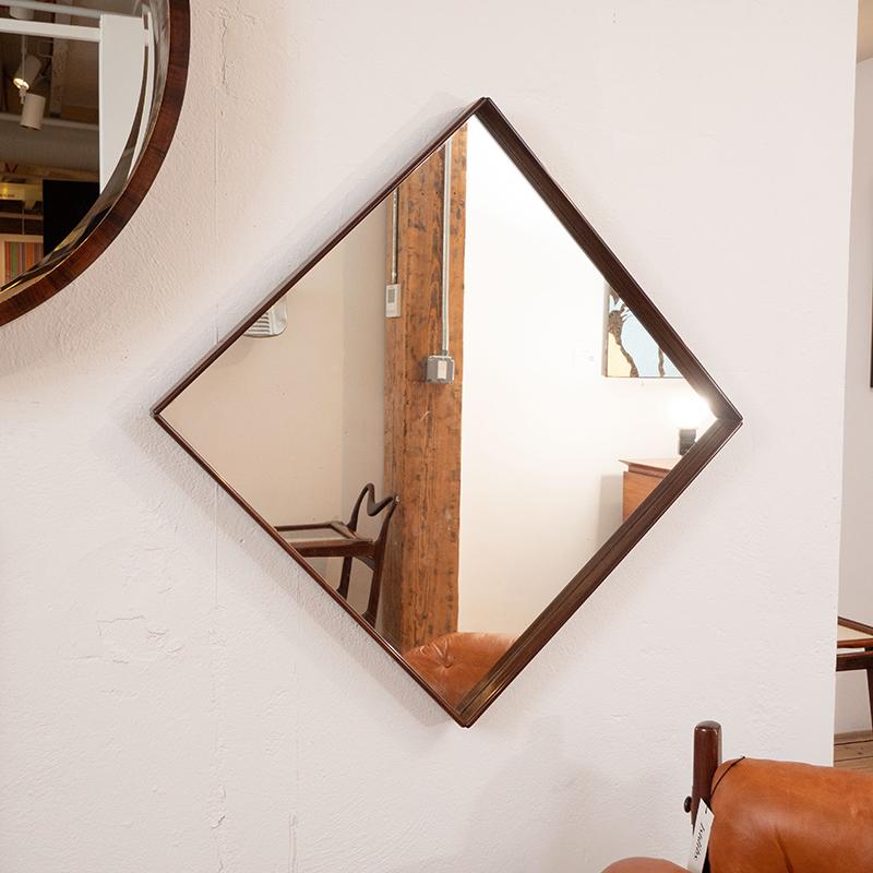 Mid-Century Modern square wall mirror nested in a delicate solid wood frame, Brazil 1960s

This graceful vintage wall mirror was manufactured circa 1960s in Brazil. It features a delicate solid wood frame with rounded-edges and beveled corners,