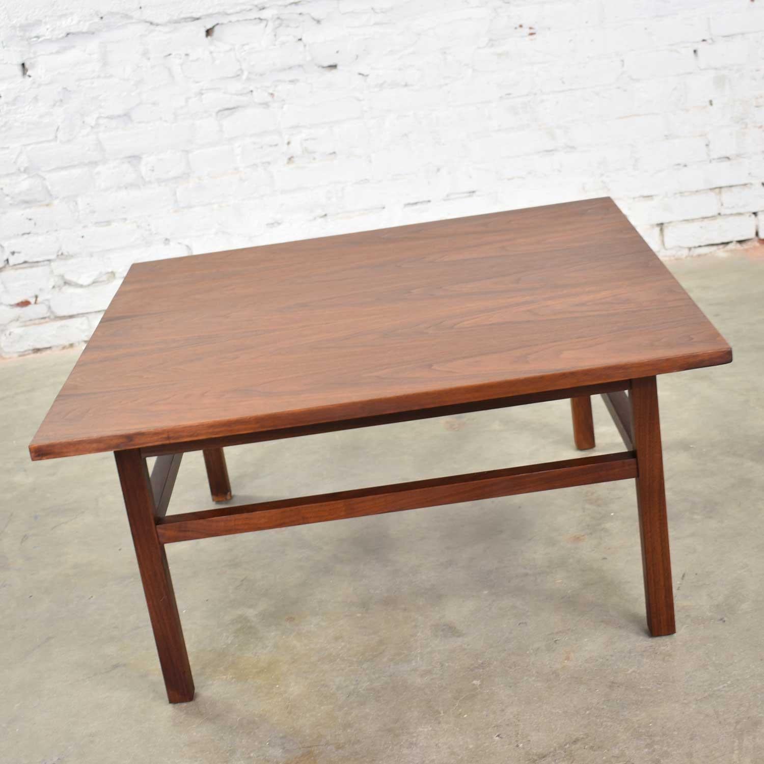 Handsome and versatile Mid-Century Modern walnut cocktail table, coffee table, side table, or end table in the style of Founders Furniture. It is made of solid walnut and in fabulous vintage condition. We have professionally restored the top and