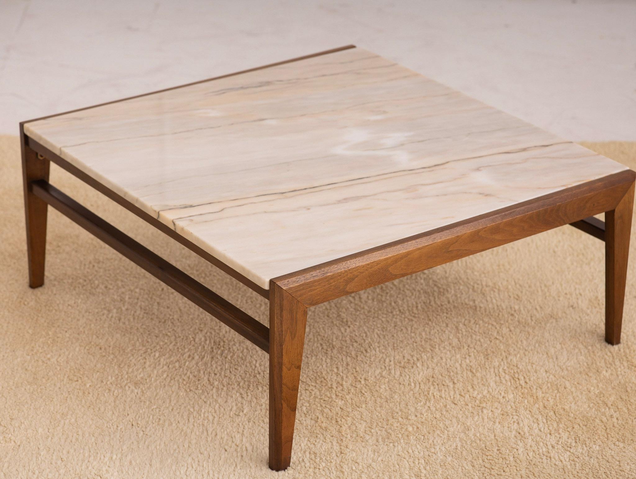 Square coffee table featuring classic mid century lines. Solid marble top sets into walnut frame. Beautiful marble variations with veining ranging from creamy beiges to light grays.