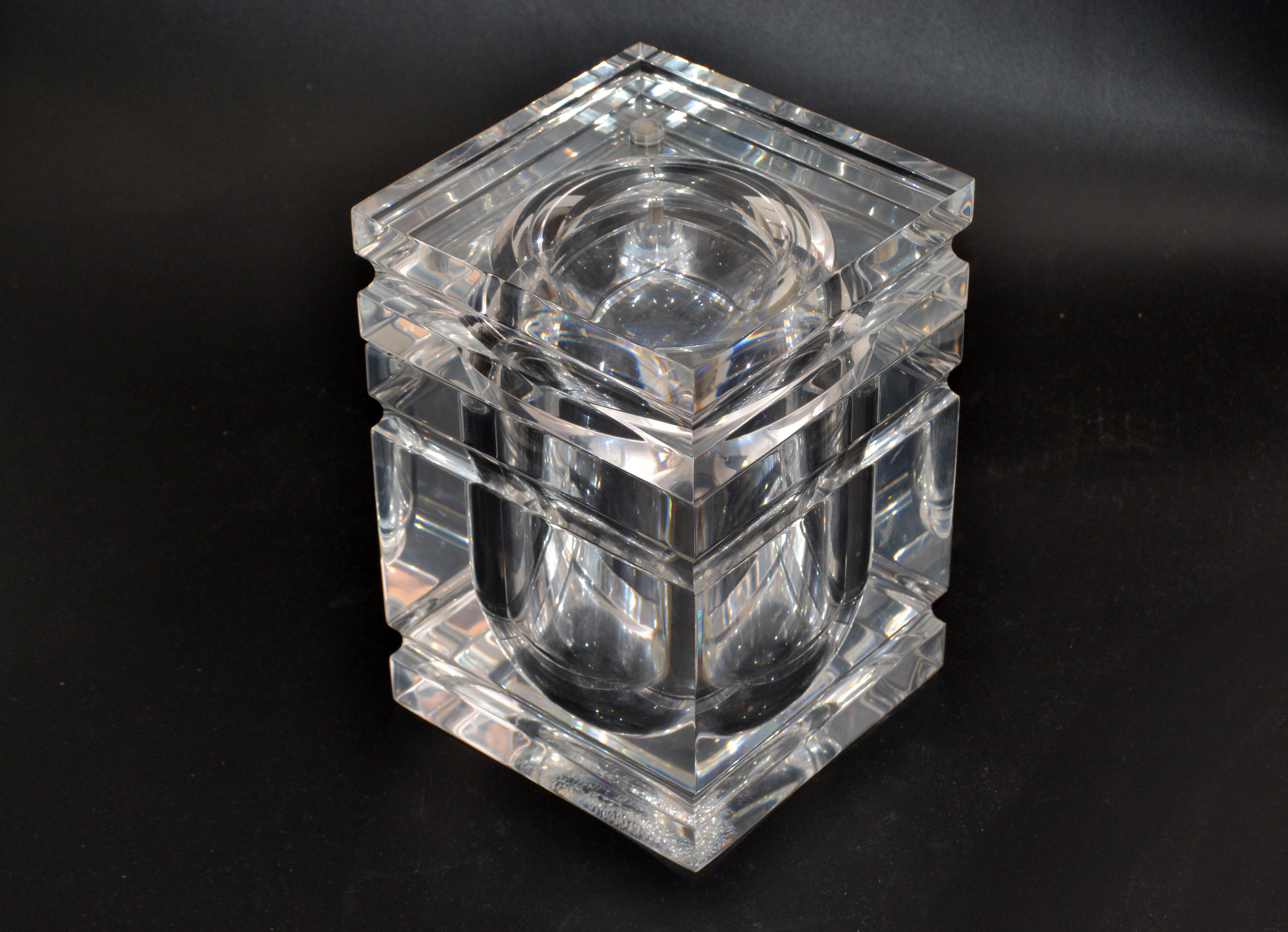 Mid-Century Modern finely detailed ice bucket in Lucite.
The tight fitted lid swings open and is attached to the bucket.
It is made out of very thick Lucite and is heavy.