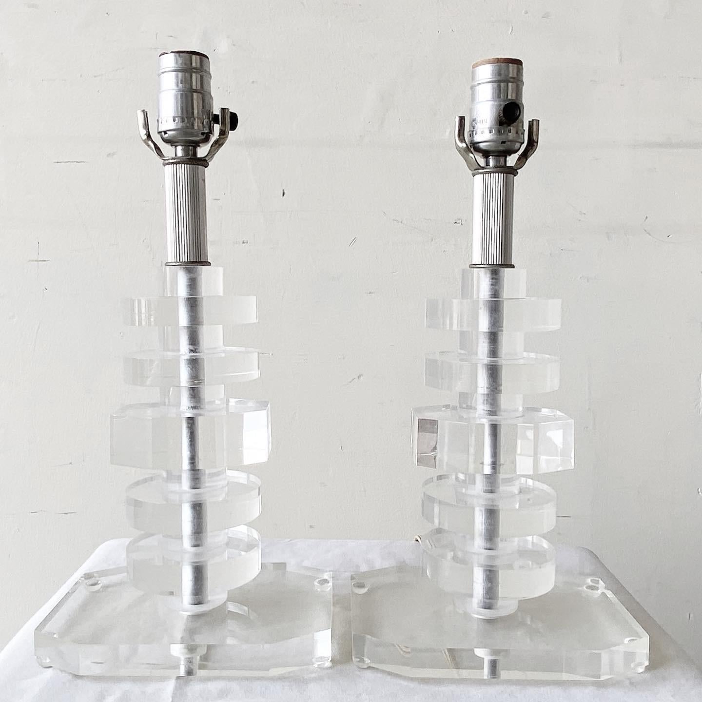 Exceptional pair of little mid century modern lucite table lamps. Each lamp is comprised of stacked lucite. 3 way lighting
