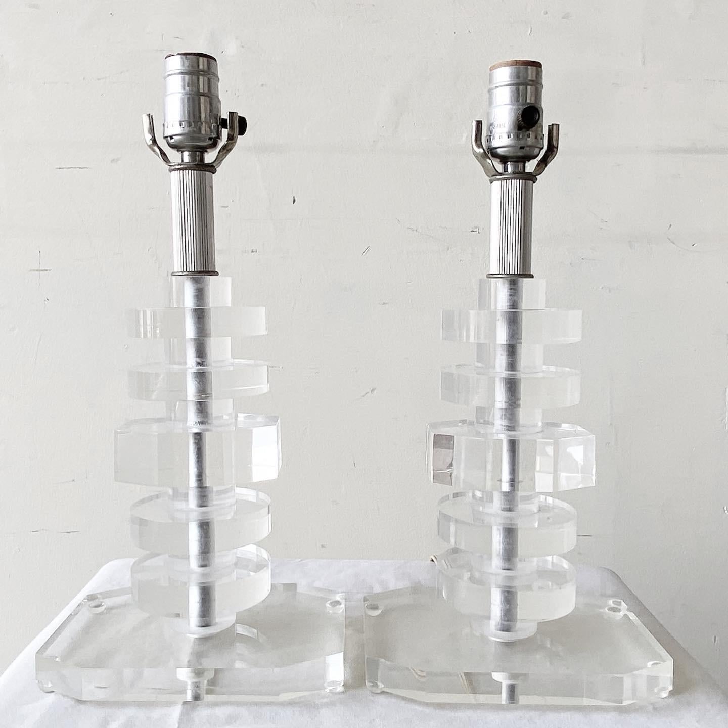 Exceptional pair of little Mid-Century Modern lucite table lamps. Each lamp is comprised of stacked lucite. 3 way lighting.
  