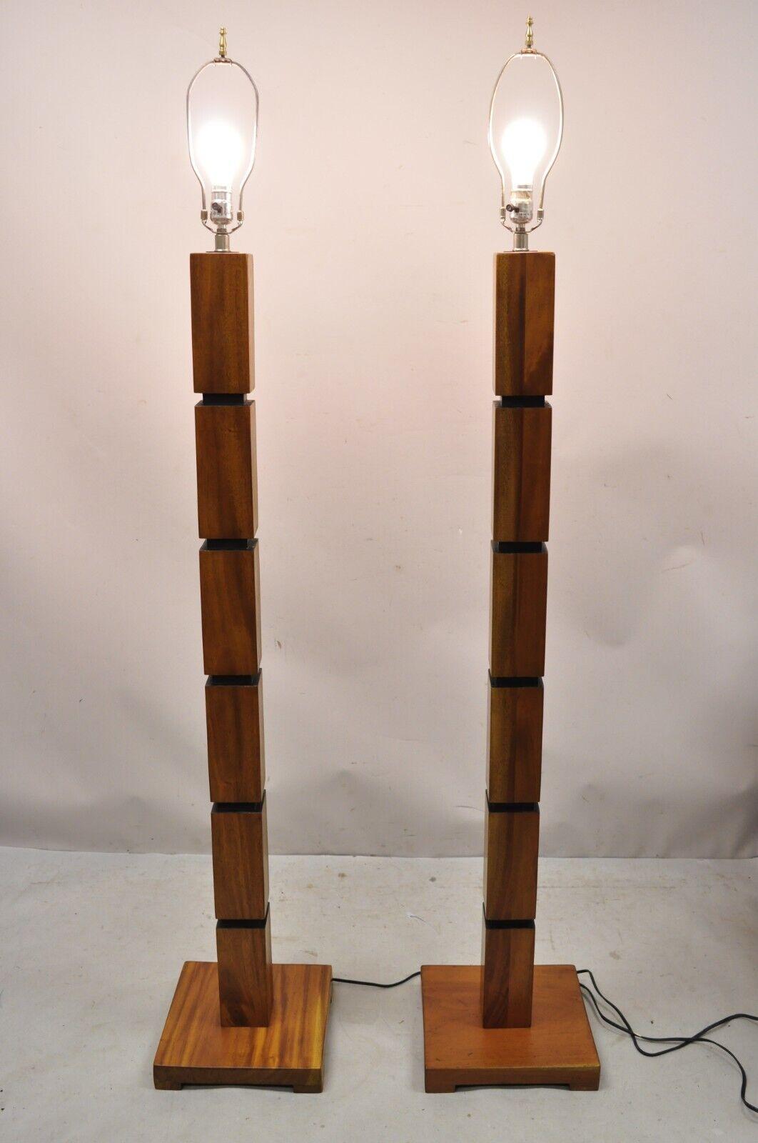 Mid-Century Modern stacked teak wood cube modernist pole floor lamps - a pair. Item features solid wood construction, beautiful wood grain, very nice vintage pair, clean modernist lines, quality craftsmanship. Circa mid to late 20th century.