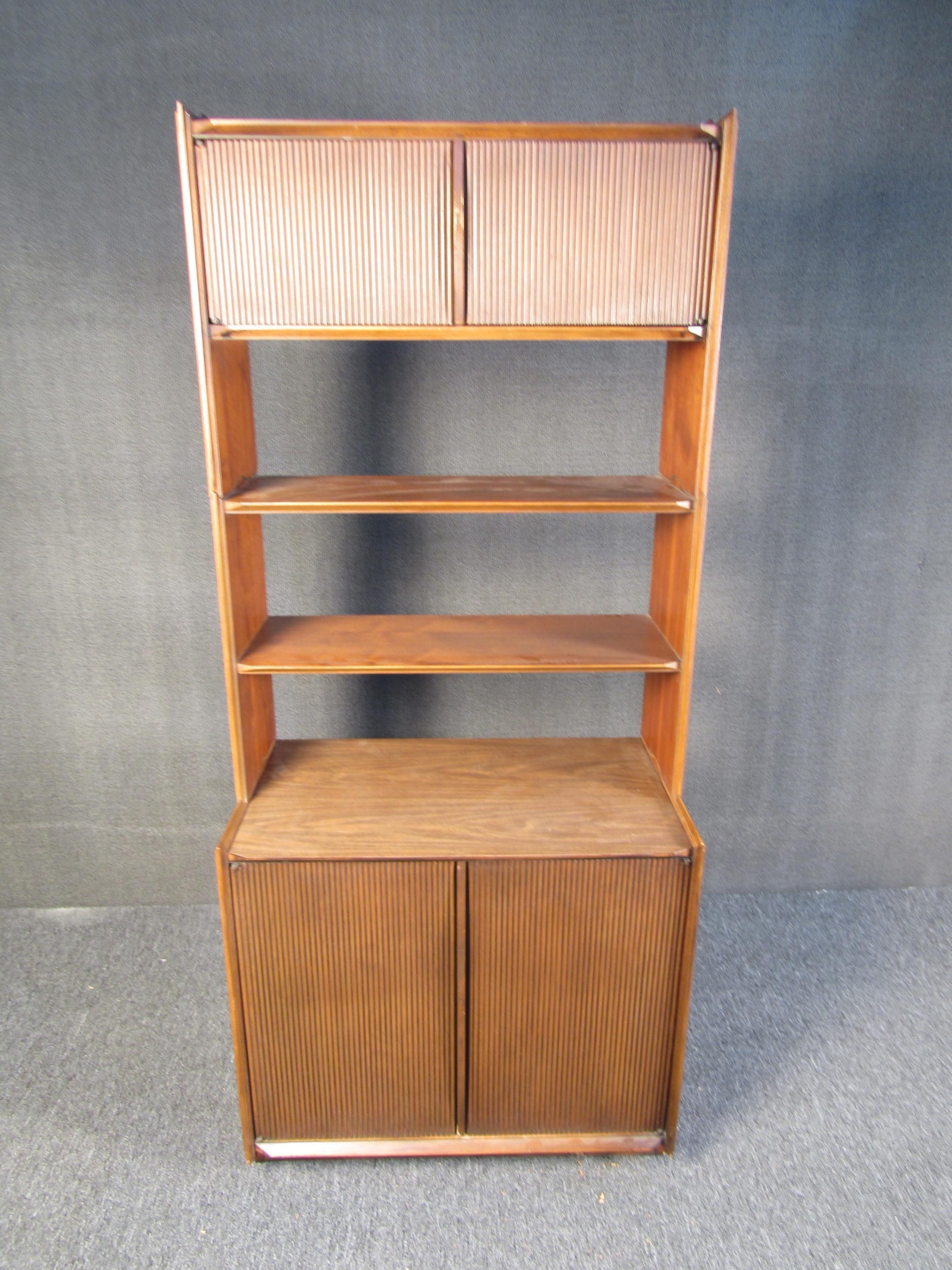 Unusual Mid-Century Modern bookshelf. Three separate components which stack on each other. Ample storage space. Nice walnut finish. Please confirm item location with dealer (NJ or NY).