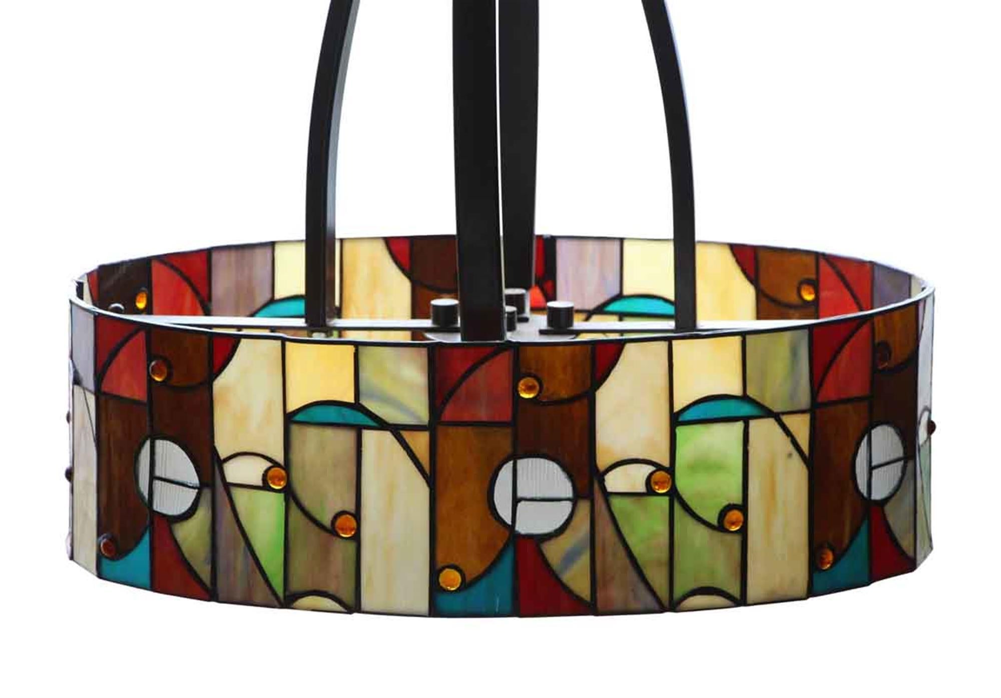 A fusion of Arts and Crafts and Mid-Century Modern styles resulting in an oval shaped stained glass pendant light. Stained glass and bronze colored fitter from 2008. Takes four bulbs. This can be seen at our 2420 Broadway location on the upper west