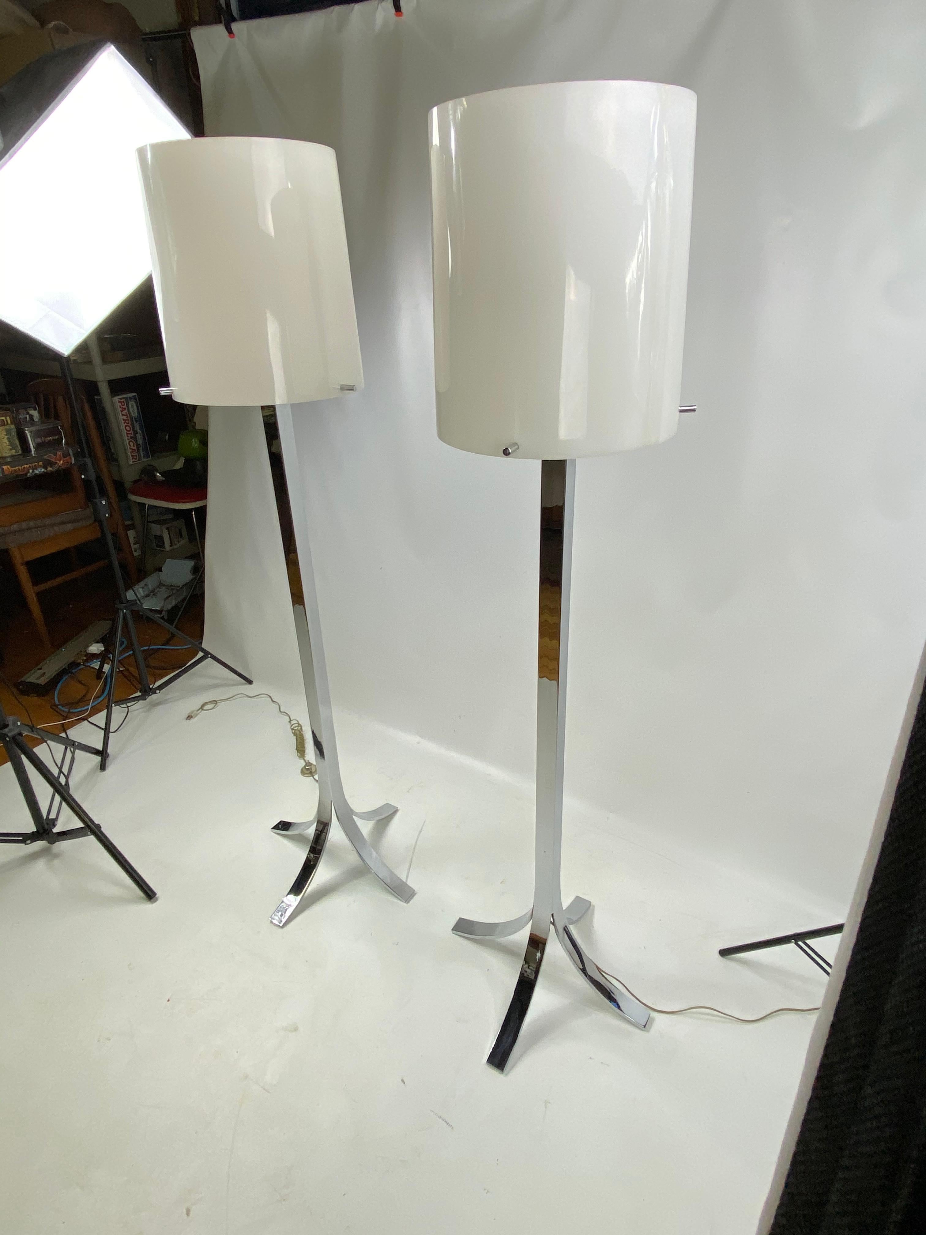 These stunning stylish midcentury chrome lamps. The lamps are very heavy and are very high quality. Lamps shades are plastic and are held up by three stainless rods that screw in.