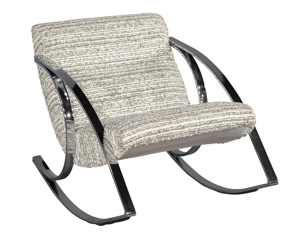 Mid-Century Modern stainless steel rocking chair. America, circa 1960’s in iconic mid-century modern styling. Featuring magnificently sculpted stainless steel frame with plush textured linen seat. Chair has ability to rock back and forth for added