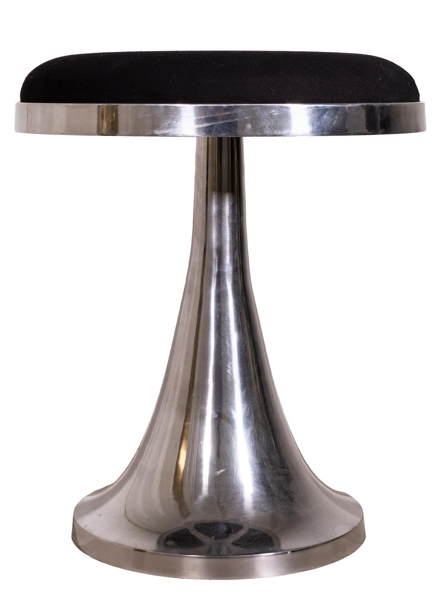 A mid century modern stainless steel tulip base swivel stool. A sophisticated vanity stool that features a chrome stainless steel finish and a black fabric cushion. This piece has a very durable, solid frame. It is in very good condition, with very