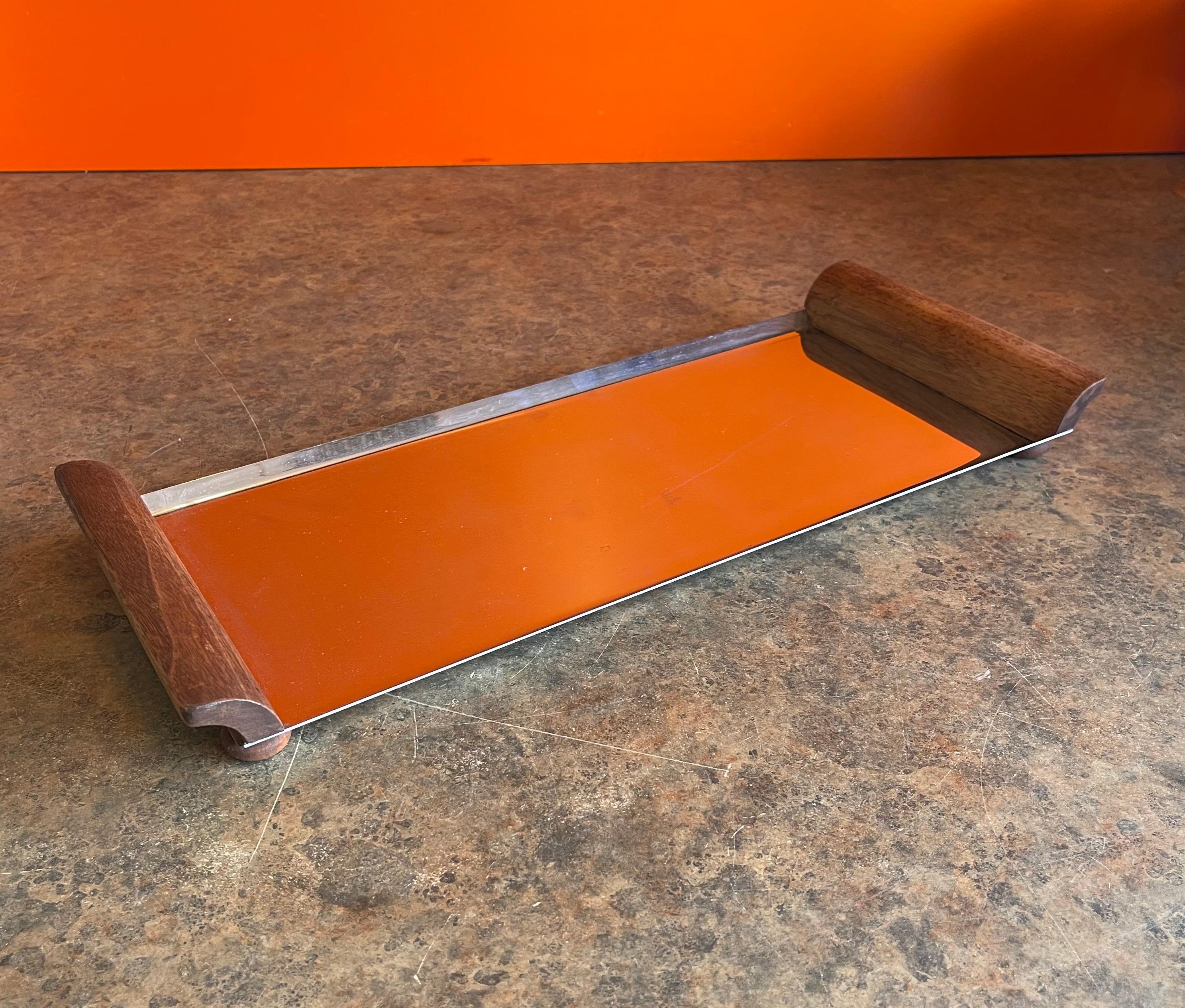 A nice MCM stainless steel serving tray with walnut handles, circa 1960s. The tray is in good vintage condition and measures 19