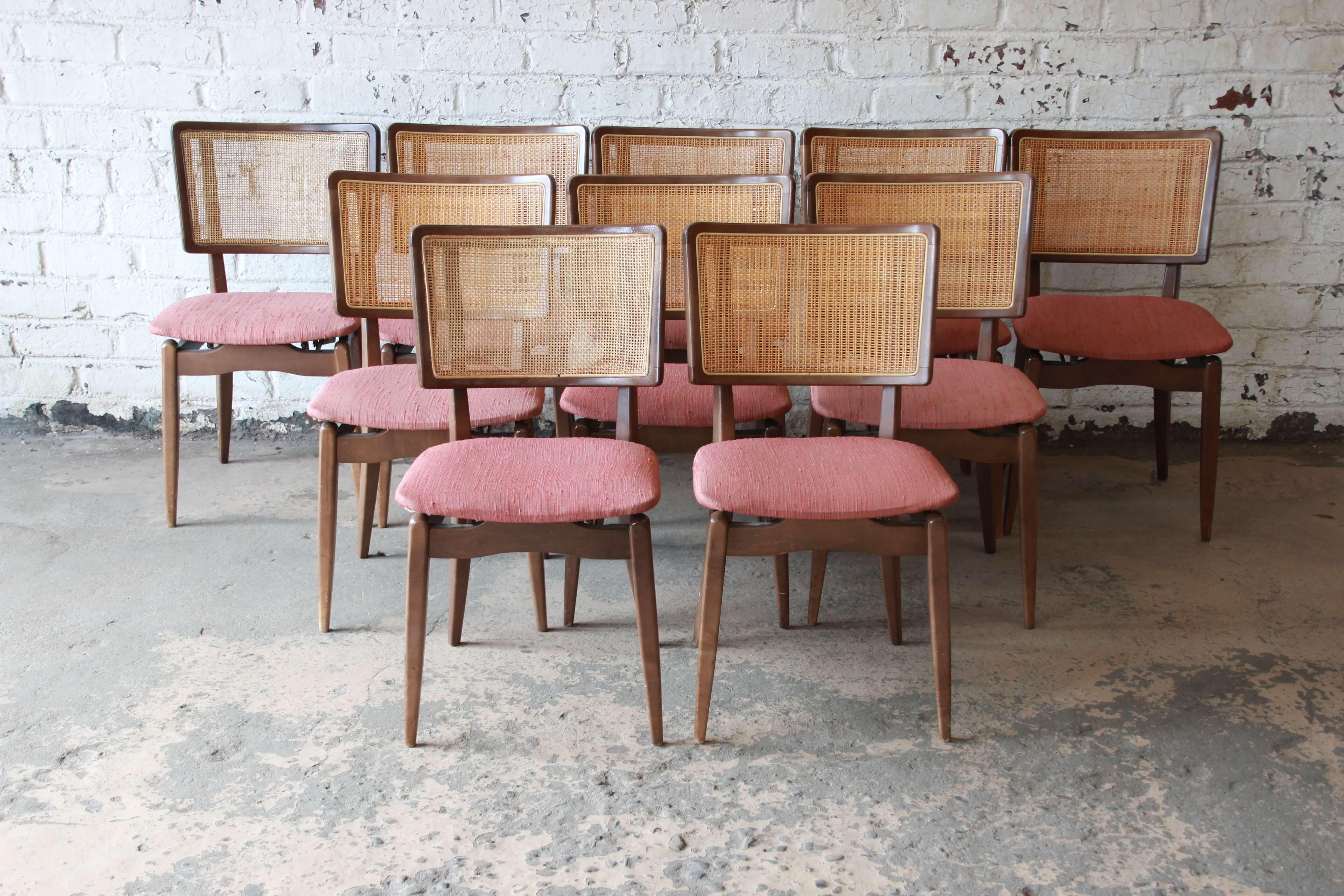 Offering a very unique set of ten Stakmore folding dining chairs. The chairs have a nice mid-century modern design with a George Nelson style back. The chairs do fold up to allow for easy transport or storage, a very unique feature while being very