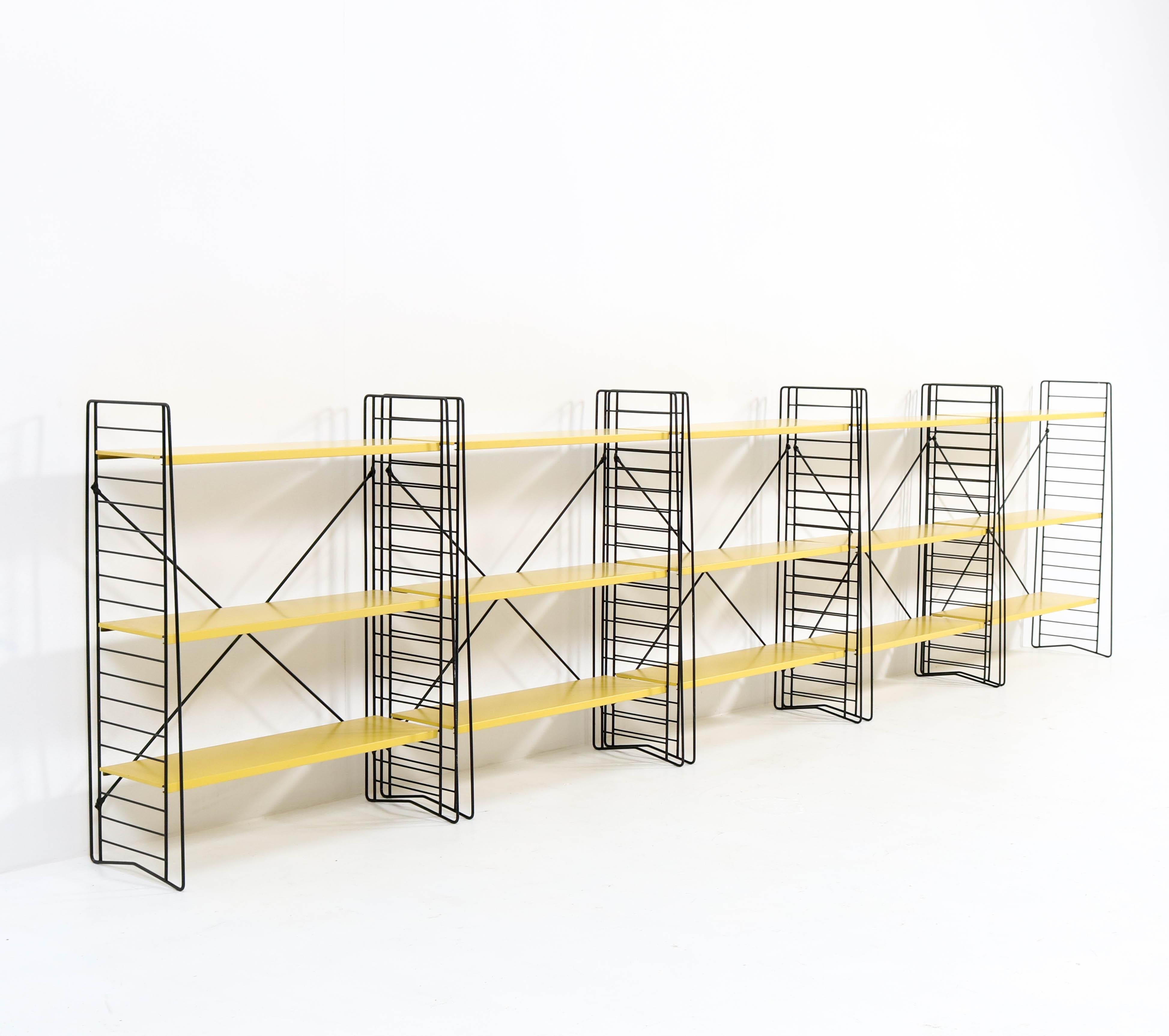 Wonderful set of five Mid-Century Modern three section standing bookshelves.
Design by Jan van der Togt for Tomado.
Striking Dutch design from the 1960s.
Original black lacquered metal frames with original yellow lacquered shelves.
All shelves