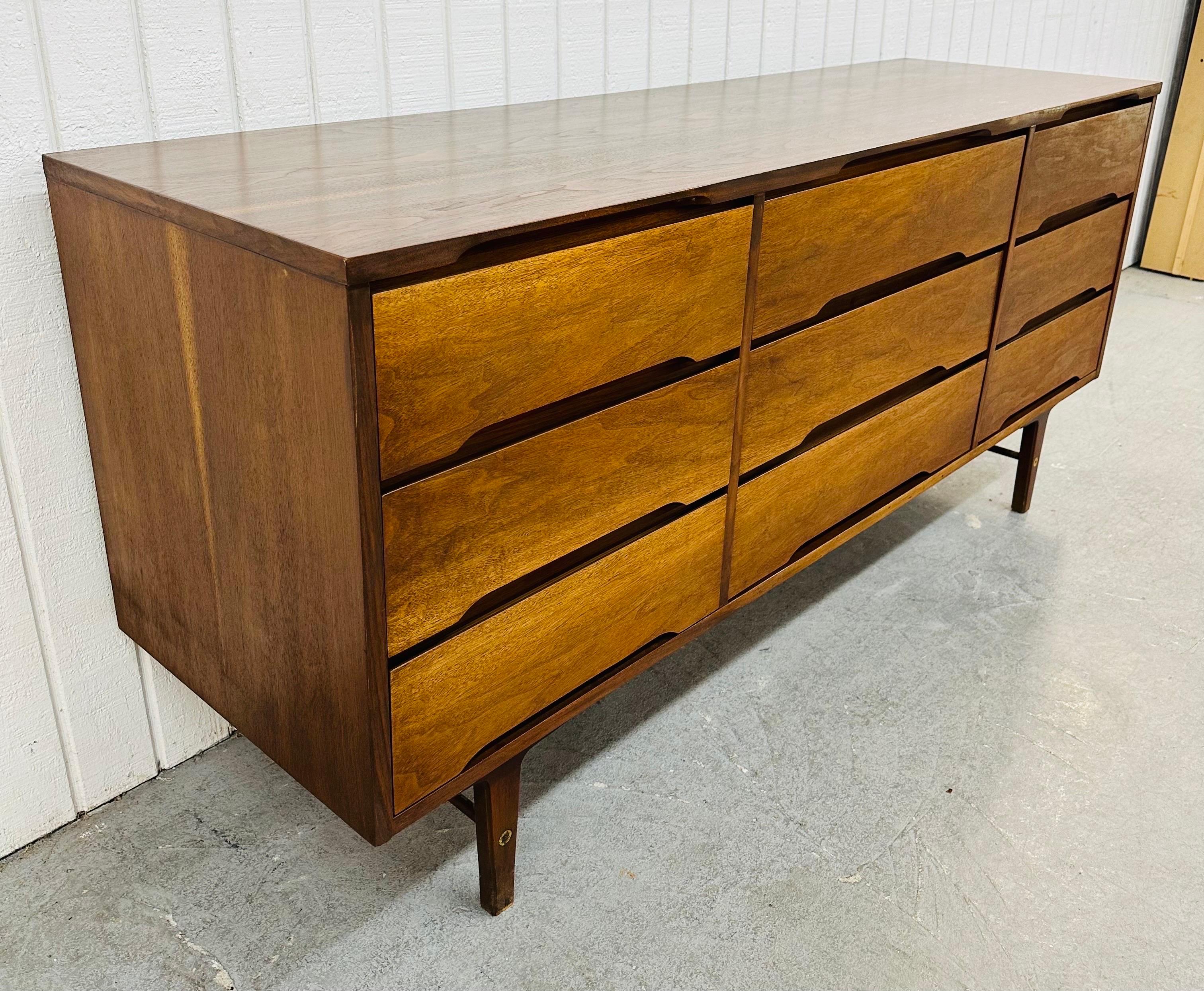 This listing is for a Mid-Century Modern Stanley 9-Drawer Walnut Dresser. Featuring a straight line design, nine equally sized drawers for storage, recessed handles for easy opening, modern legs with stretcher support, and a beautiful walnut finish.