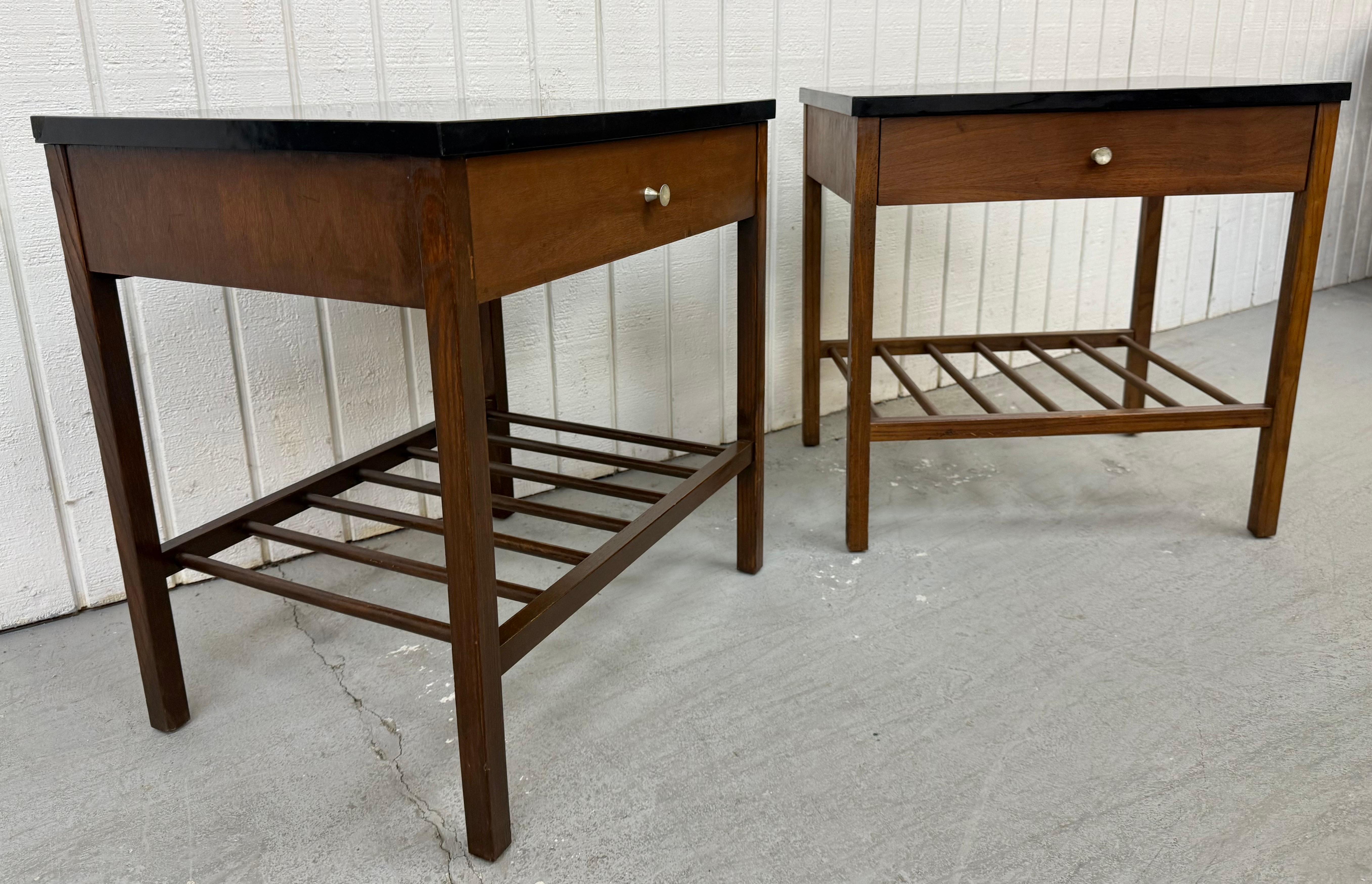 This listing is for a pair of Mid-Century Modern Stanley Walnut Nightstands. Featuring a straight line design, single drawer with chrome pull, bottom magazine storage space, modern legs, and a protective black laminated top. This is an exceptional