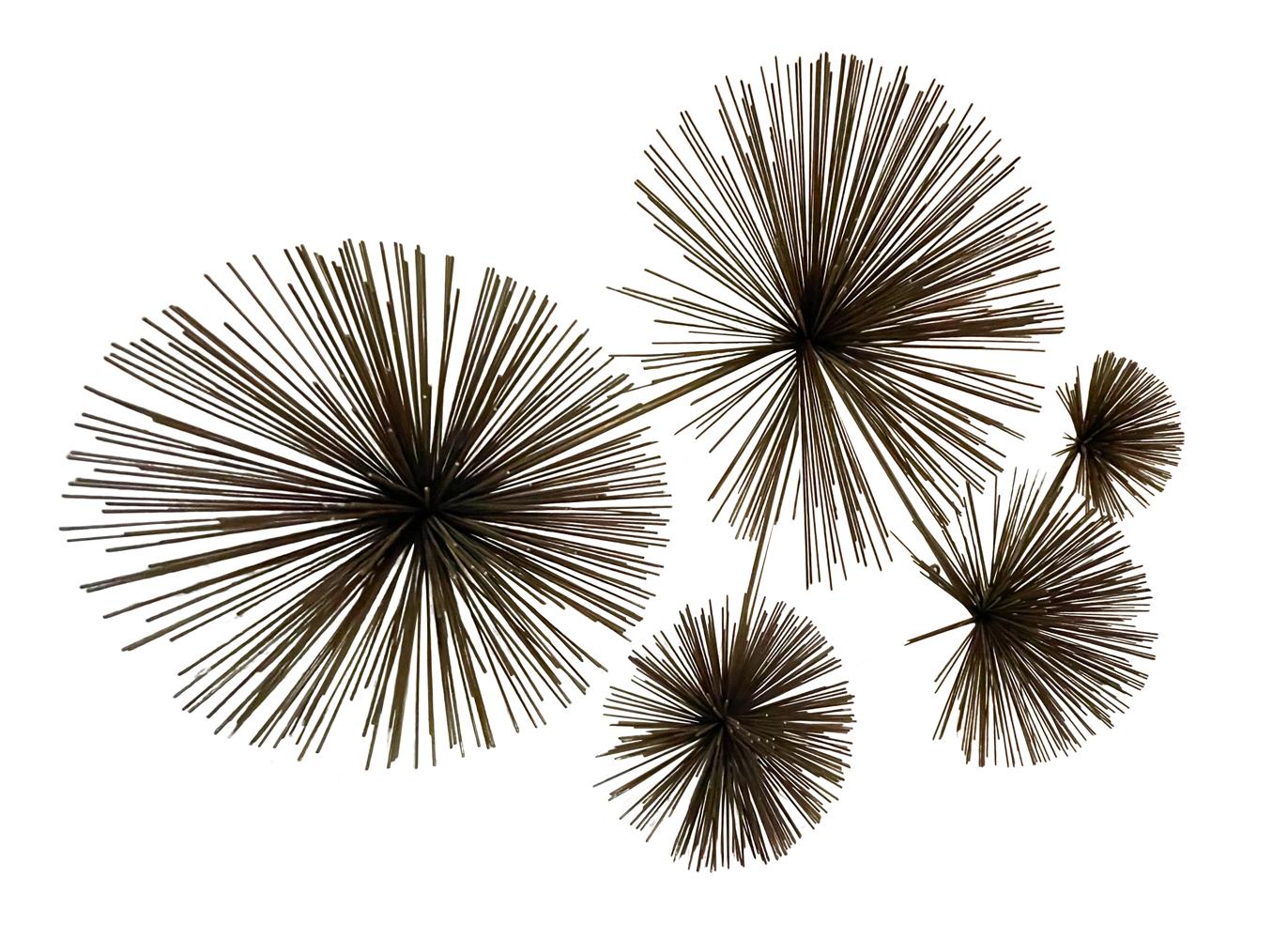 A vintage multi starburst wall sculpture by Curtis Jere circa early 1970's. It consists of brass / bronze colored steel wires. Ready to use condition.