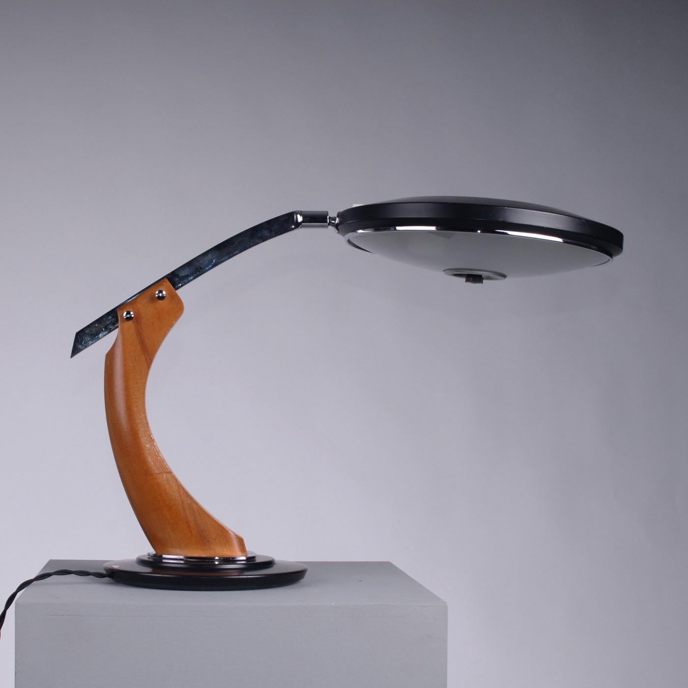 Mid-Century Modern steel and oak desk lamp from manufactured by Fase, Spain, 1960.
Classic Fase model President Medium with oak arm and chrome steel rod on black lacquered base, aluminium shade and opaline glass. Newly wired with fabric braided